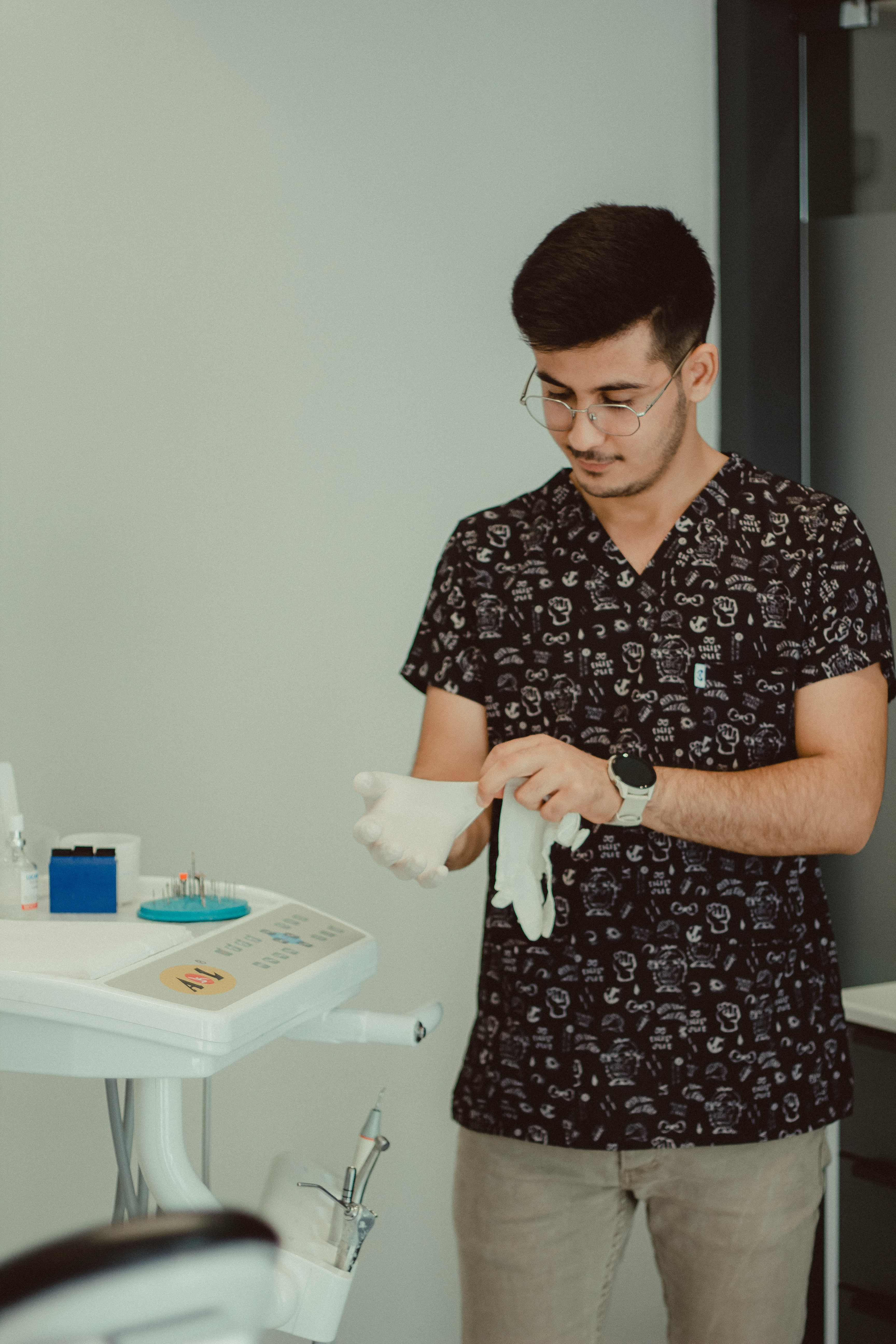 Hygienist putting on gloves in dental office