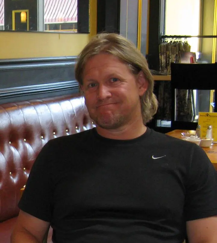 Image: Man posing for picture wearing black nike t-shirt.