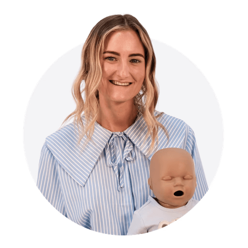 Close-up portrait of a blonde woman in translucent pink glasses and a white shirt on a soft blue background.