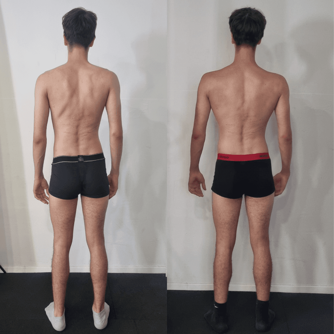 A serene outdoor seating area with two chairs, surrounded by lush greenery and a glassed-in structure.