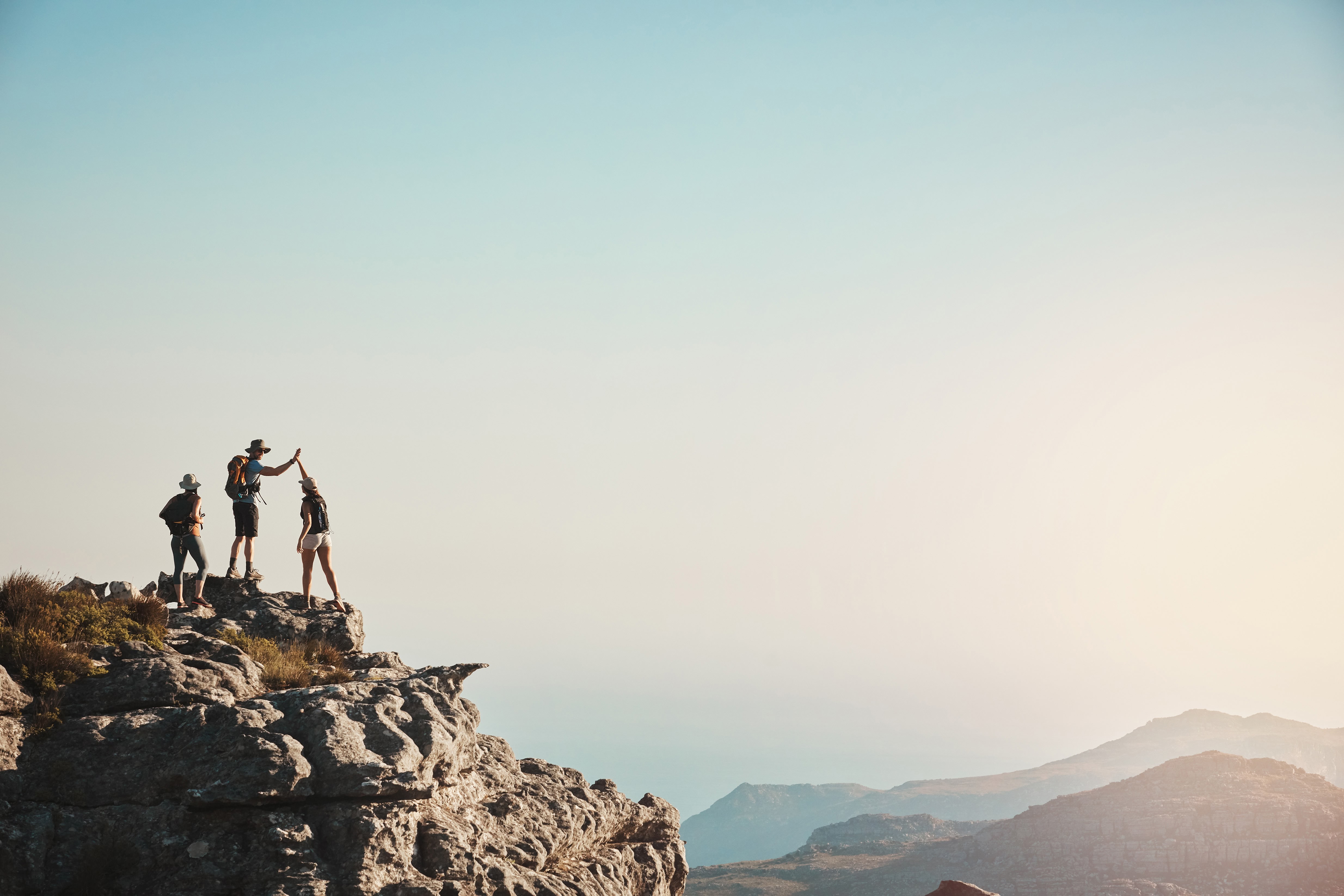 A hiking group reaches the mountain summit
