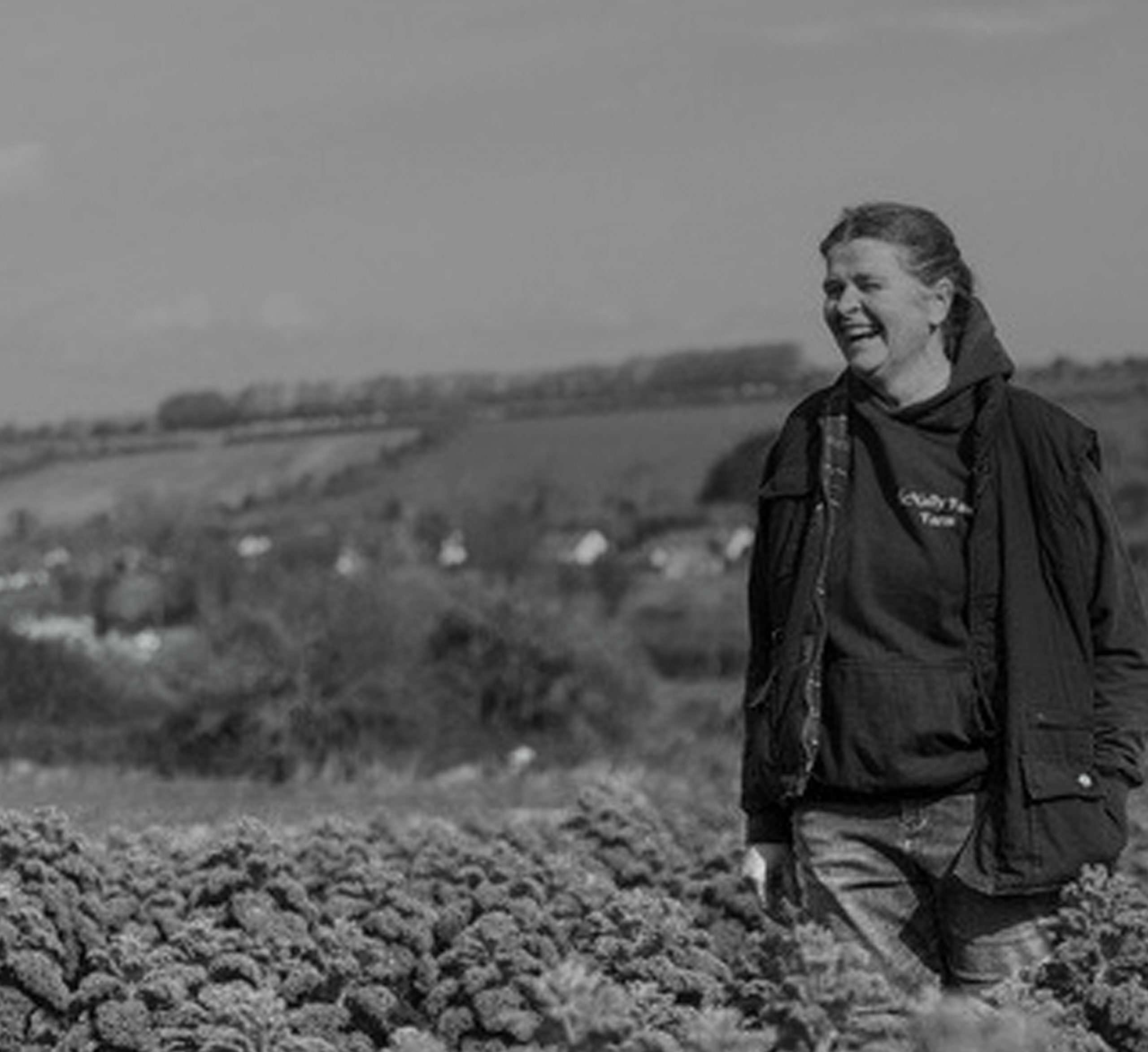 Owner of McNally Family Farm laughing while being in a Field Owners of Beechlawn Organic Farm laughing in the field while supplying their goods to As One Restaurant Dubliln