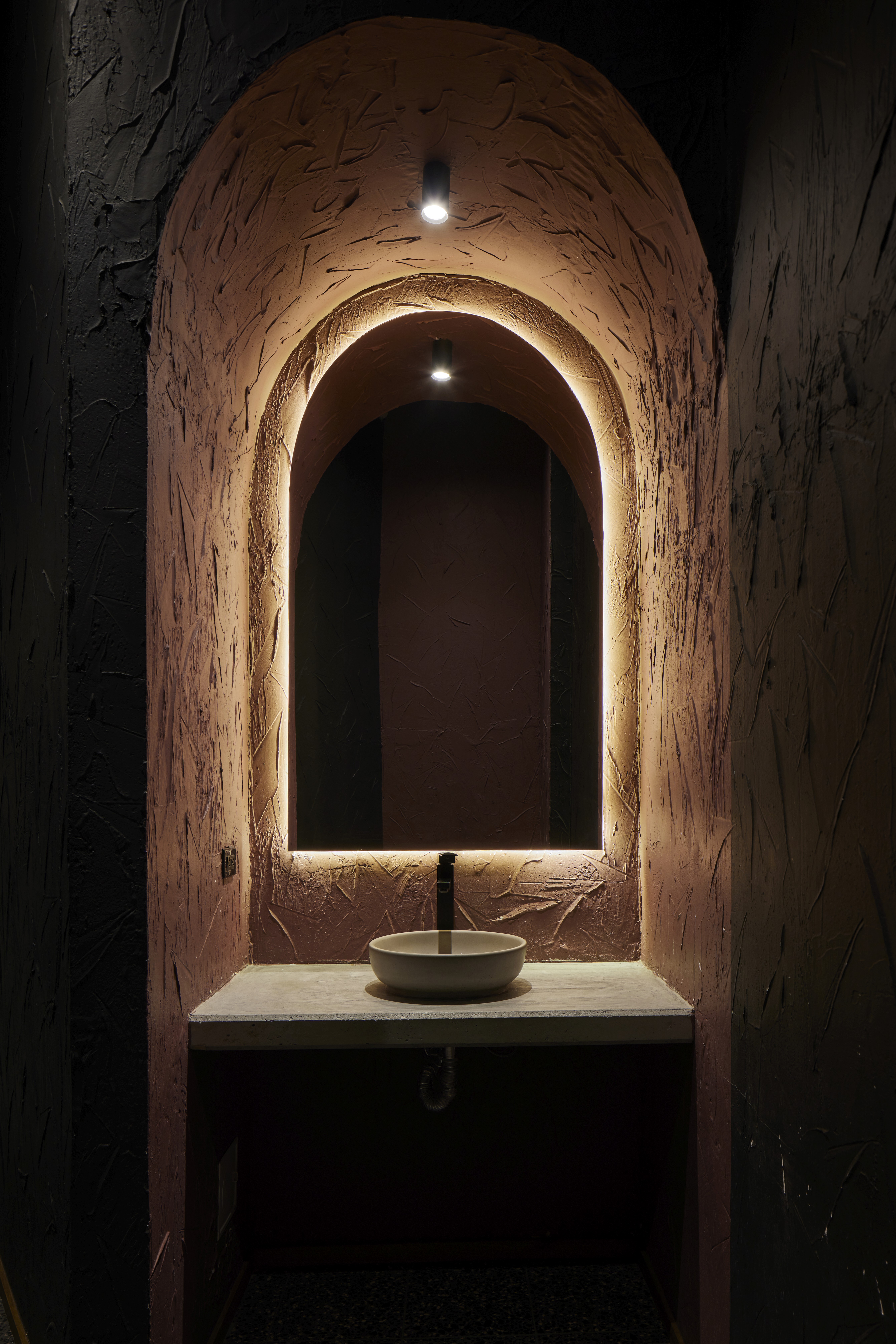 Double-height interior with flowing sculptural forms and warm raking light