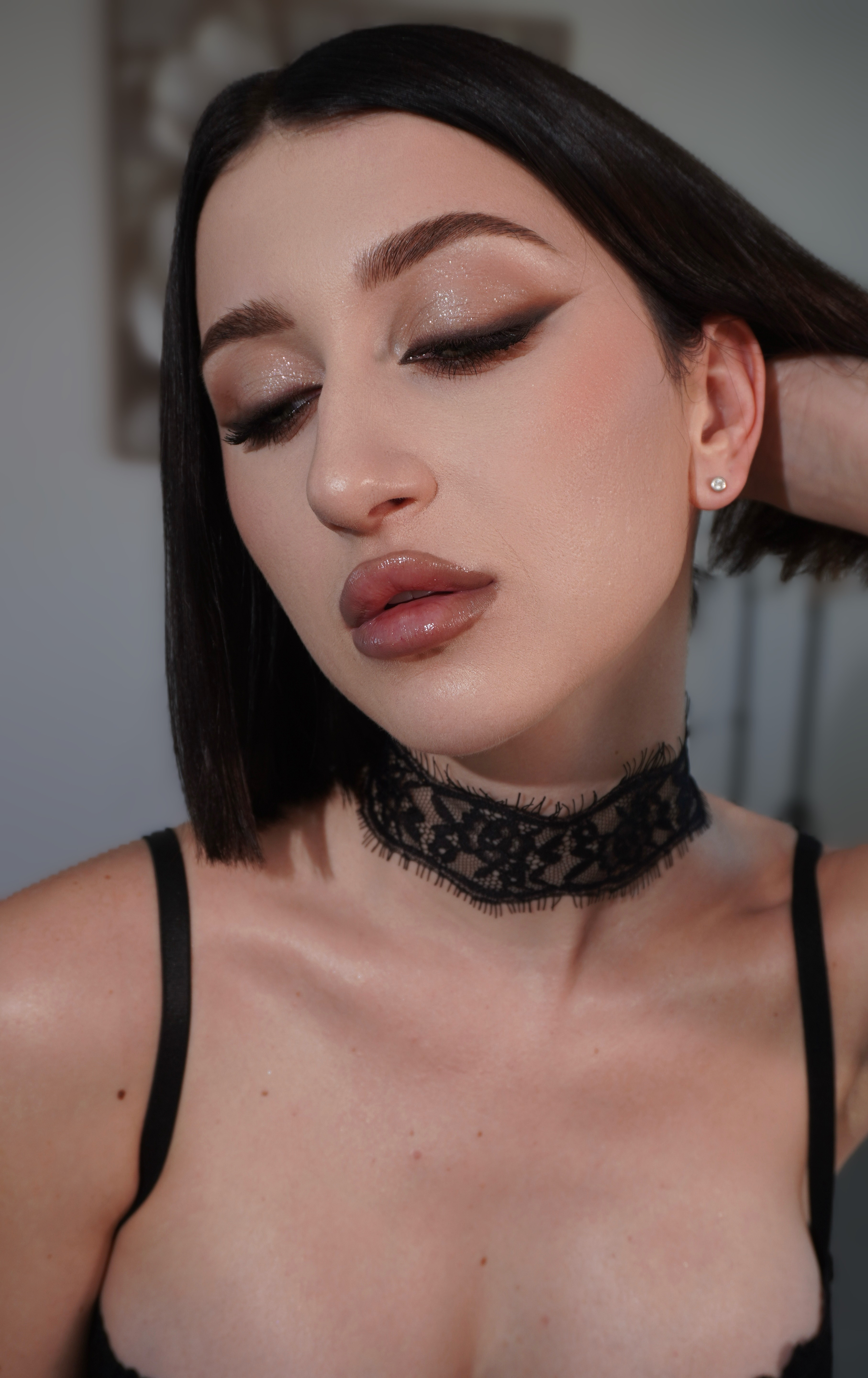A person’s feet being gently soaked in a warm water bowl, decorated with fresh flowers and smooth stones. The scene exudes relaxation and holistic healing.