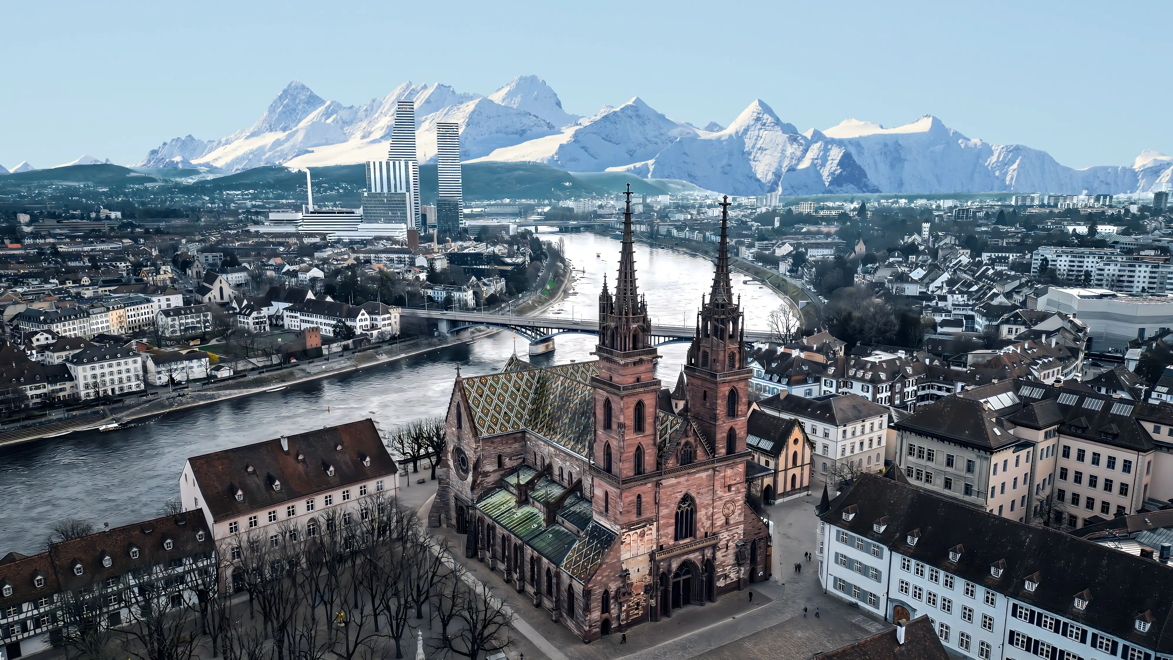 Aerial view of Basel Minster and the Rhine River with the Swiss Alps beyond