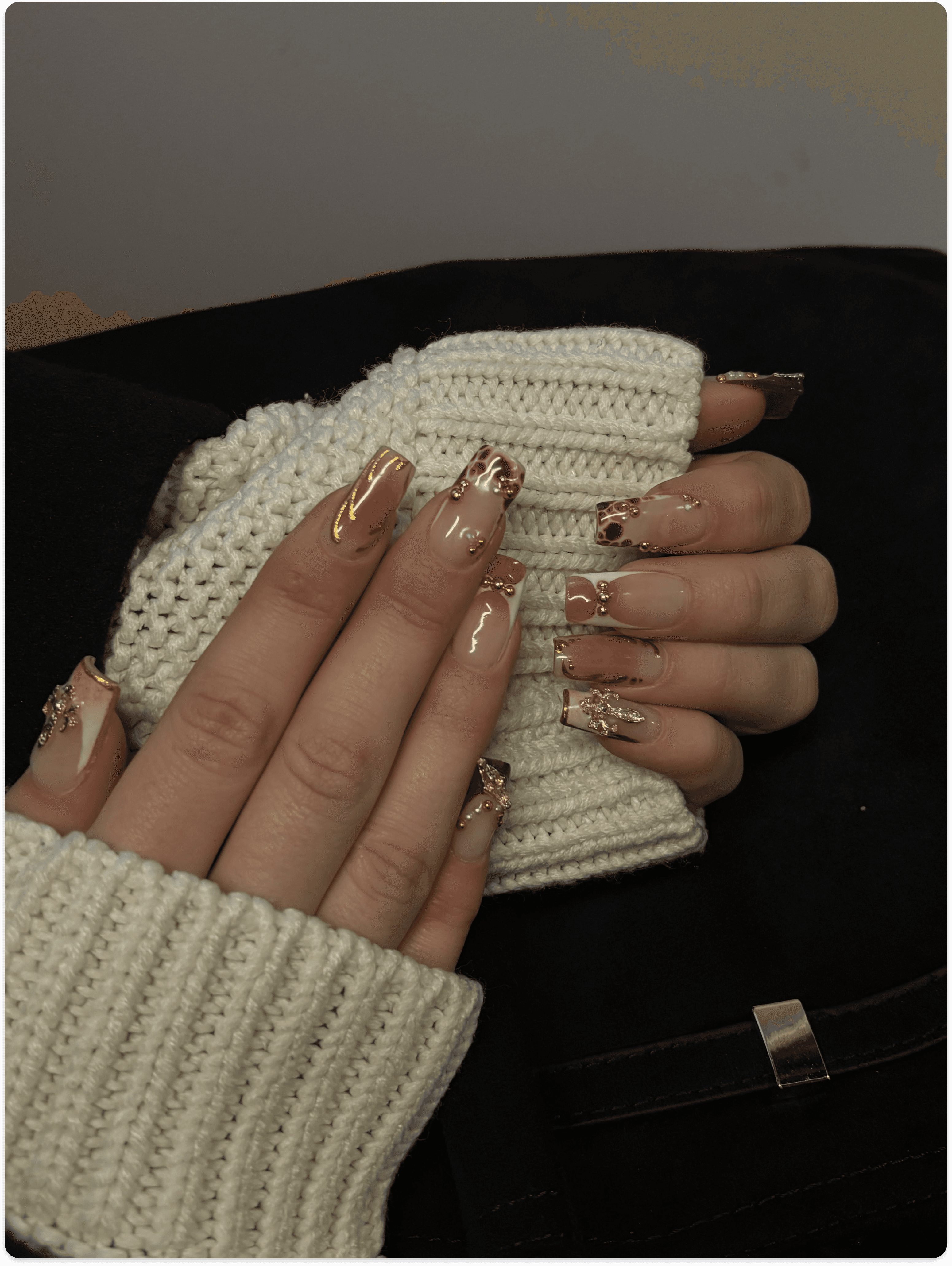 Hand with glittery pastel nails in sunlight