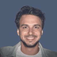 man wearing green crew-neck top and eyeglasses with black frames looking at side