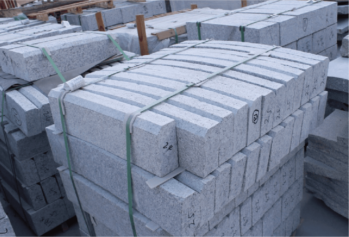 Bundled kerbstone slabs ready for shipment, indicating the machine's capability to produce large quantities efficiently.