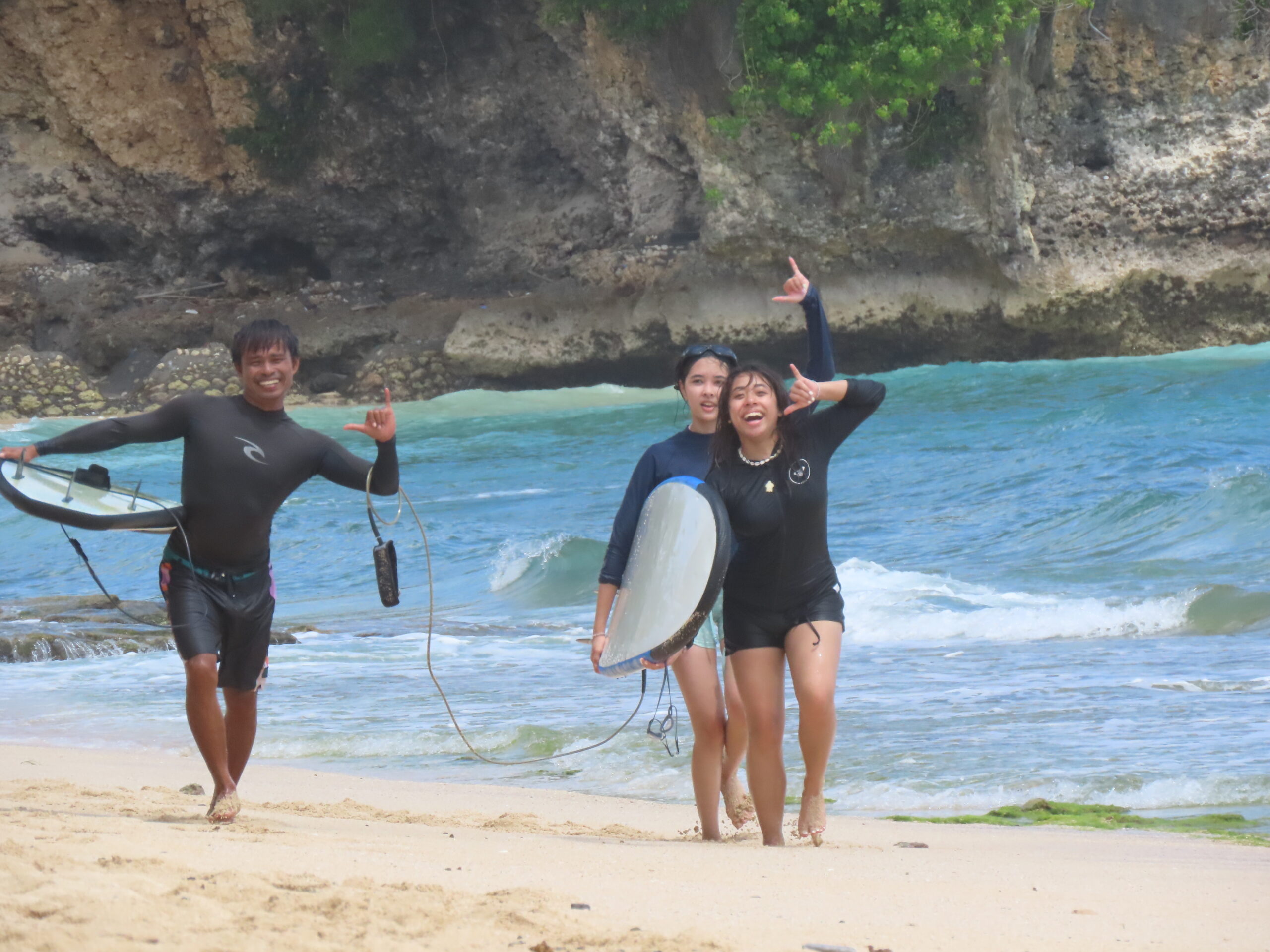 A man stading with Surfboard