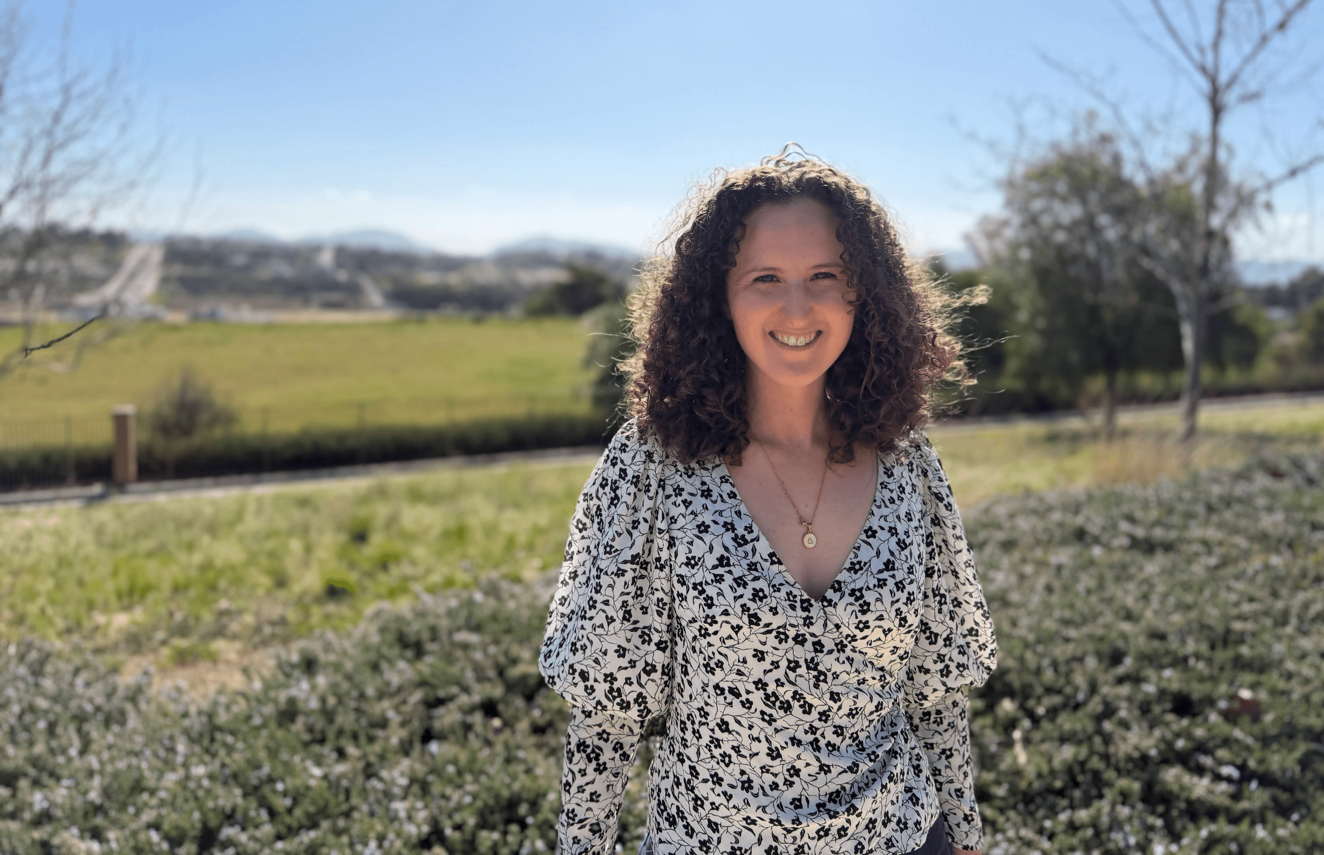 Picture of Theresa smiling outdoors in a green park
