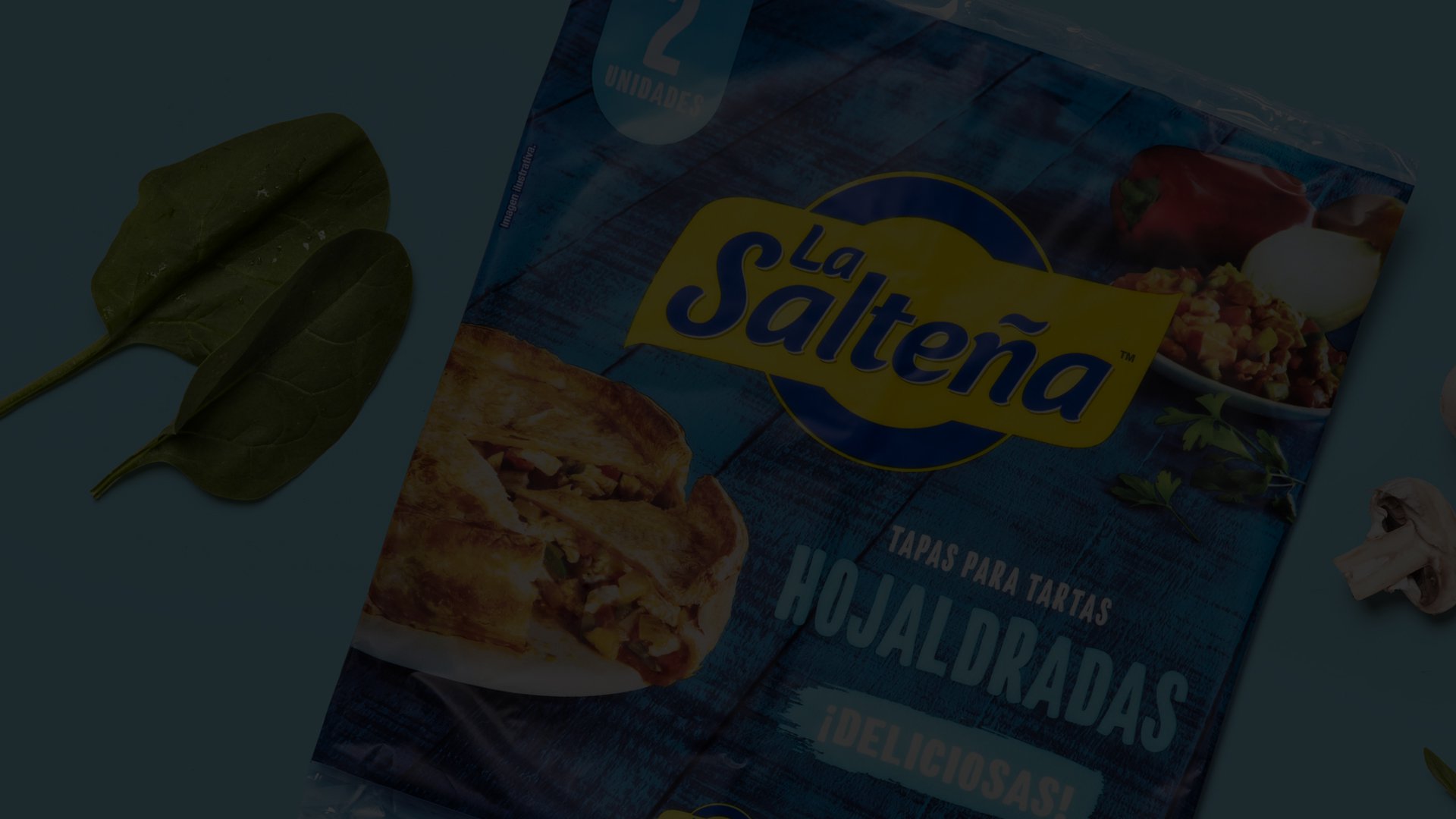 Packaging of "La Salteña" pastry dough for savory pies is on display. Spinach leaves are on the left, and a mushroom is on the right.