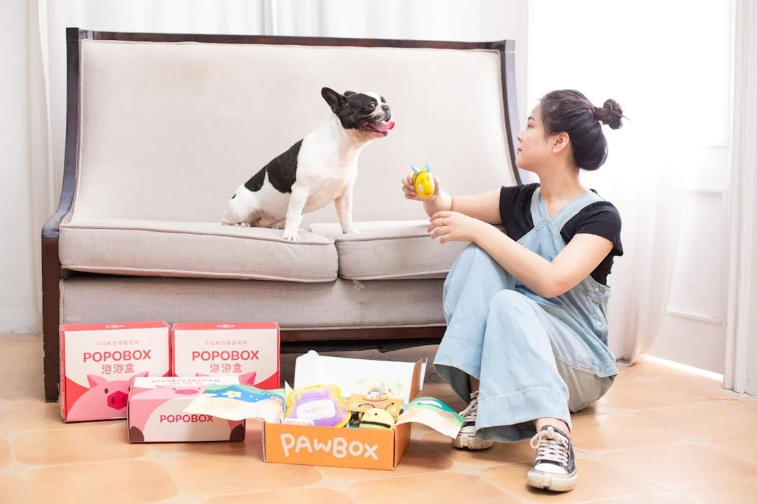 A woman and her dog enjoying treats.