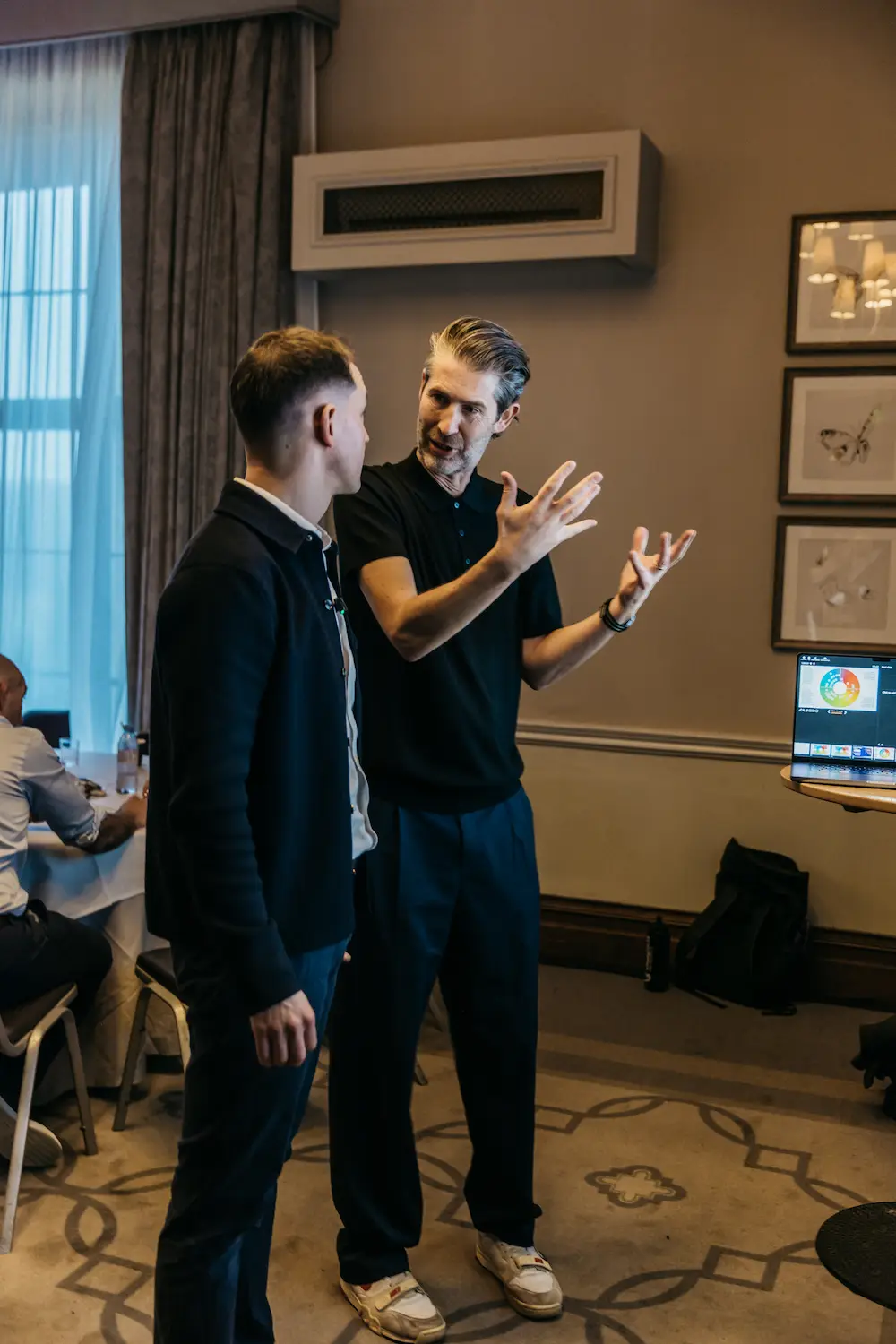 Two people playing Wii video games in a room.