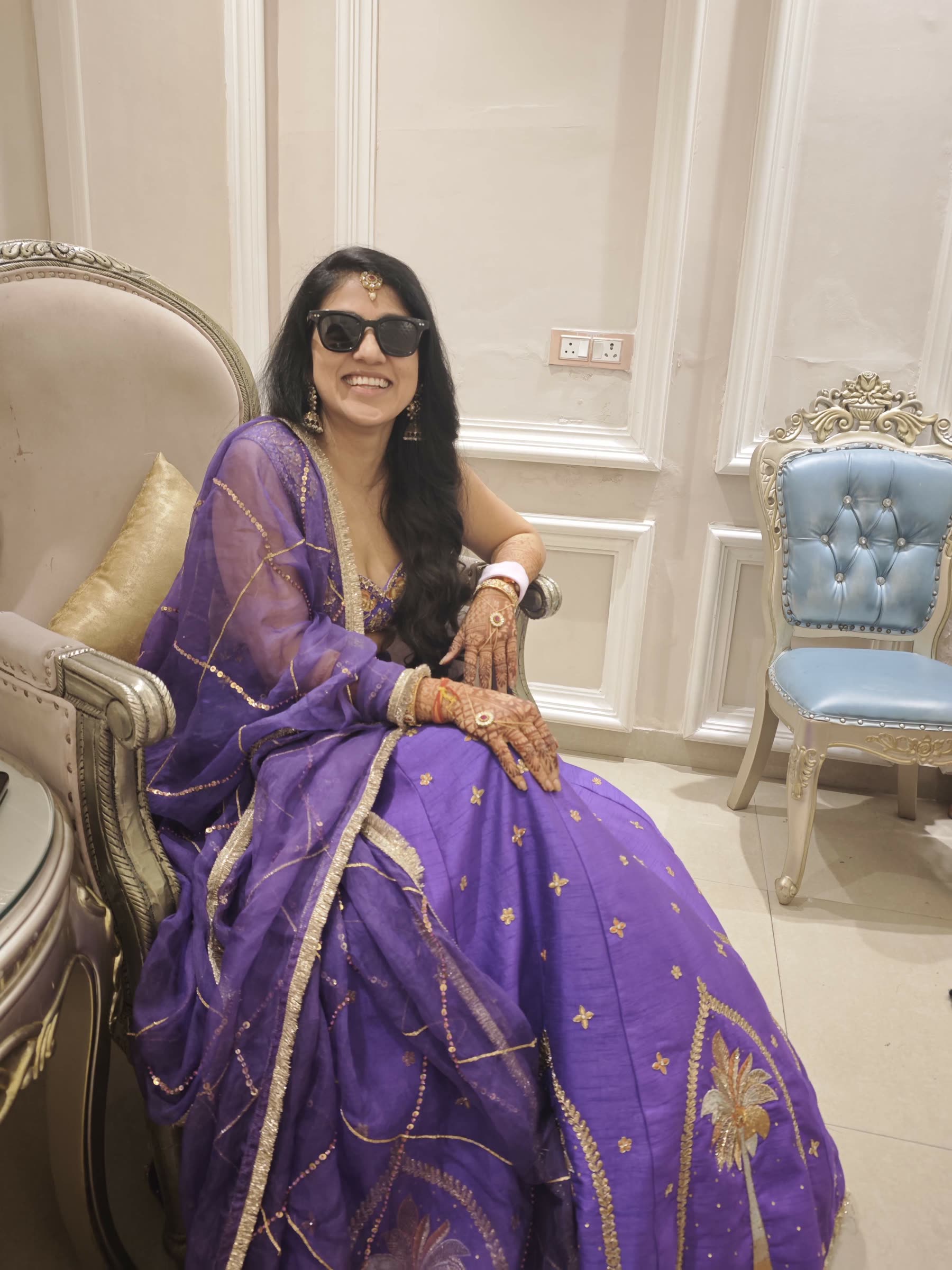 Sarika smiling in purple wedding attire