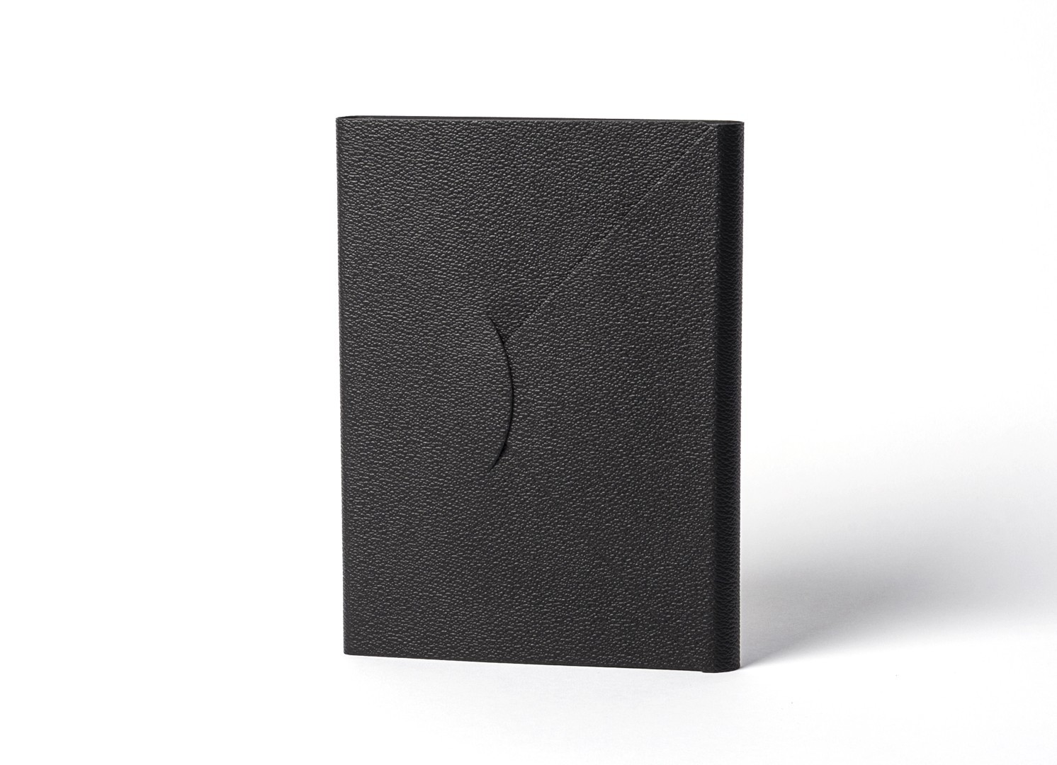 Front view of standing black notebook with curved tuck-in flap.