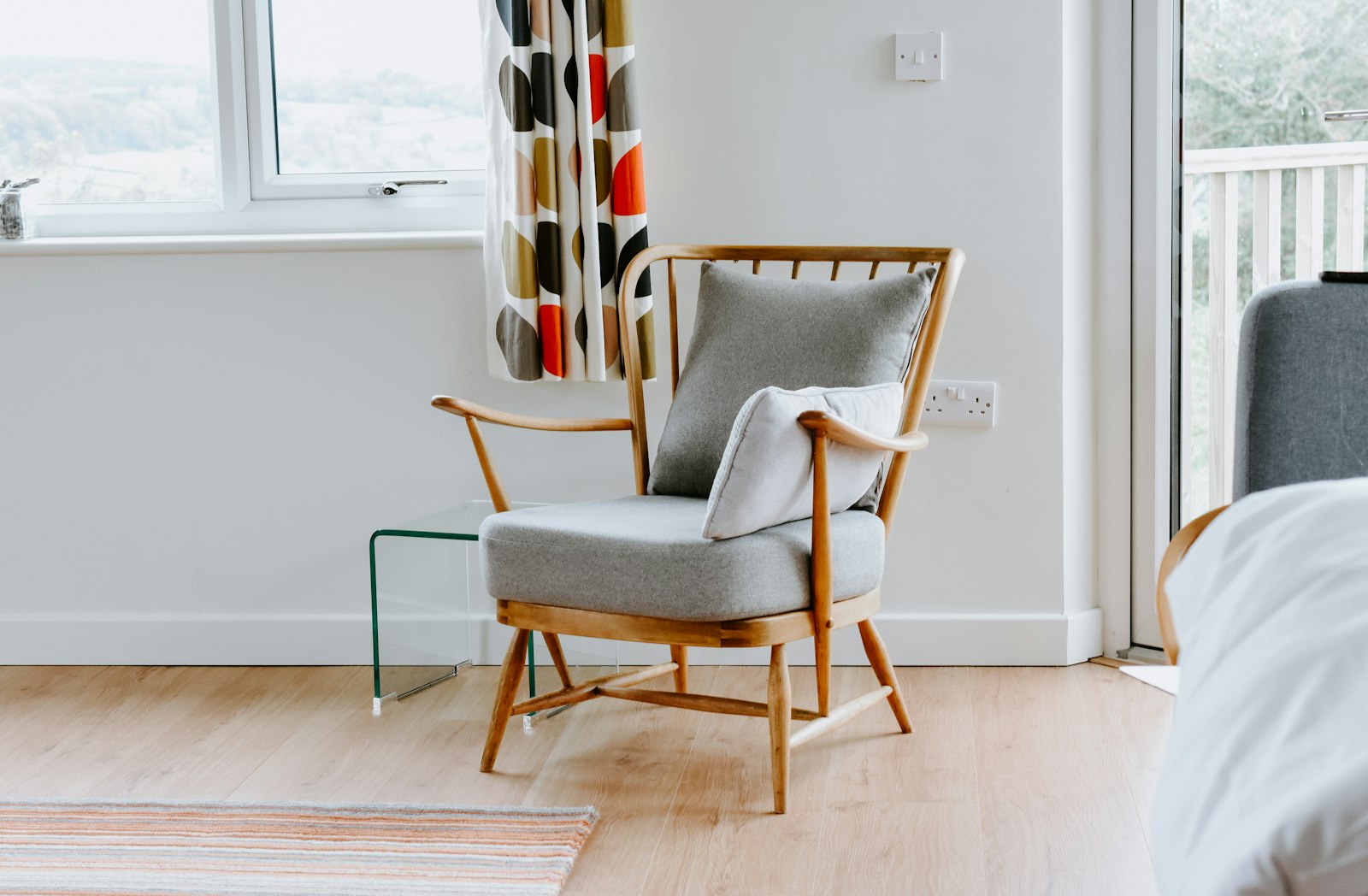 A wooden chair beside a window in a quiet room