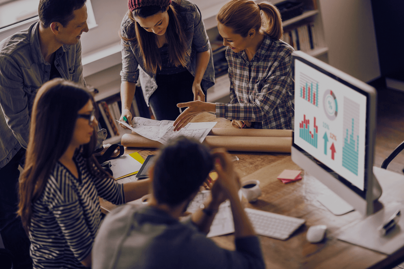 three people sitting in front of table laughing together