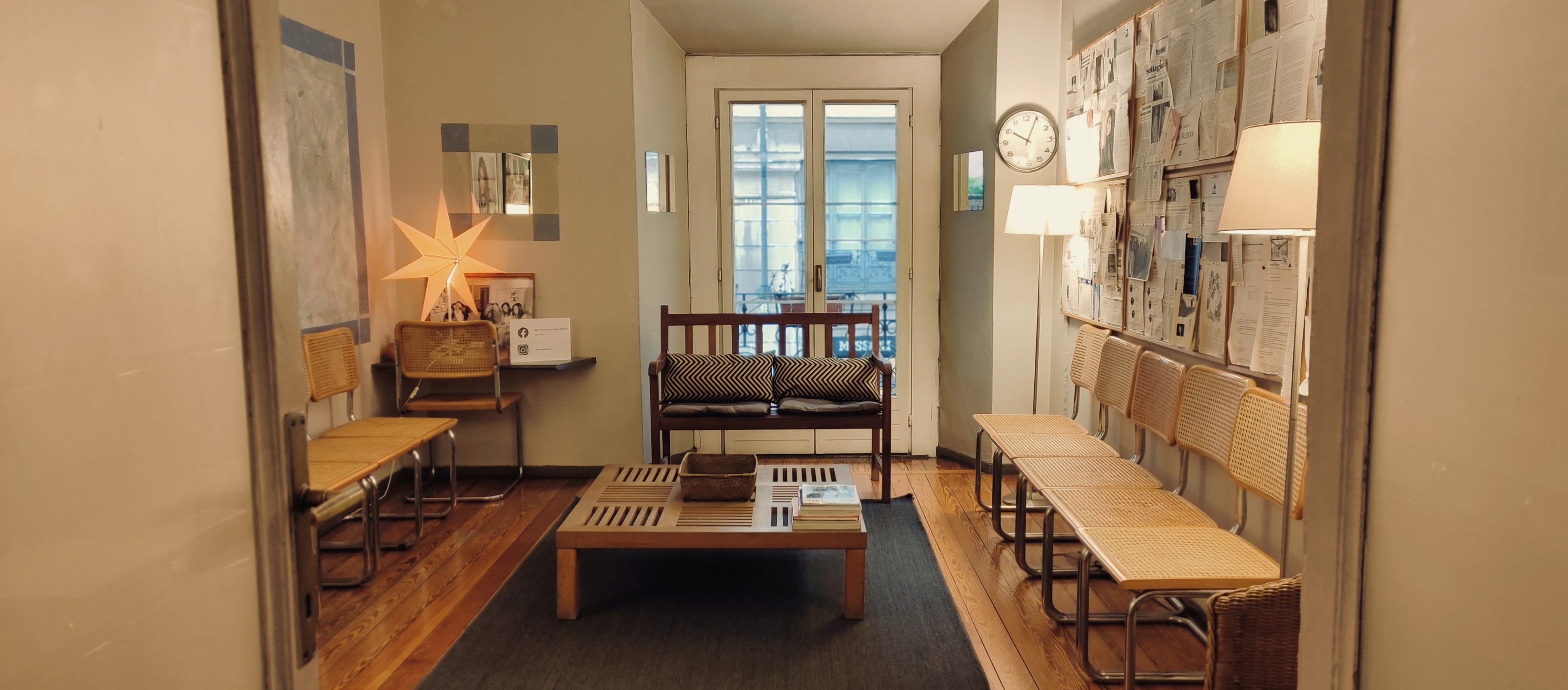woman in white sweater holding black round frame