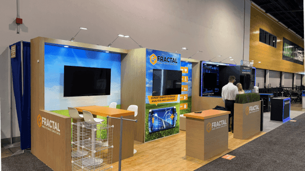 Fractal RE+ Southeast 2024 energy storage booth with technical demo counter, branded product graphics, screen display, and buyer-facing clean energy presentation