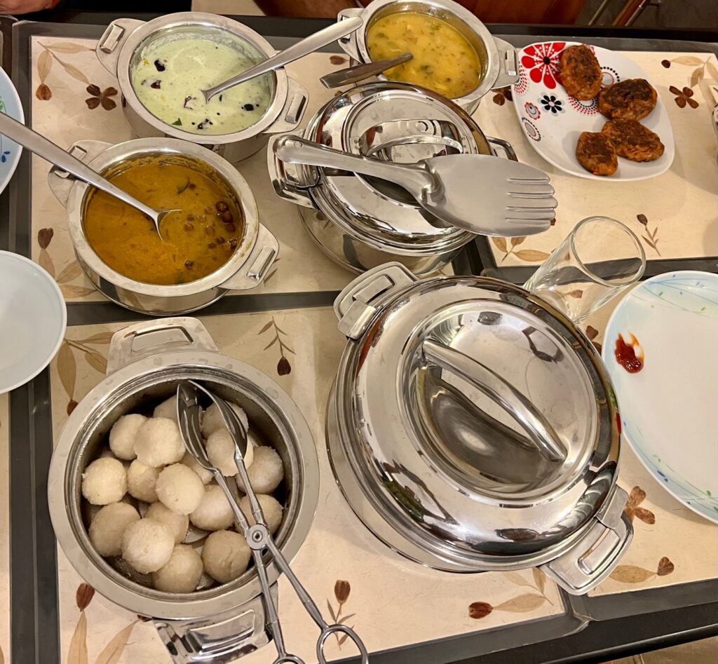 Food at the AirBnB Cottage. Chana, chutney, dal, cutlets, rice and plates. 