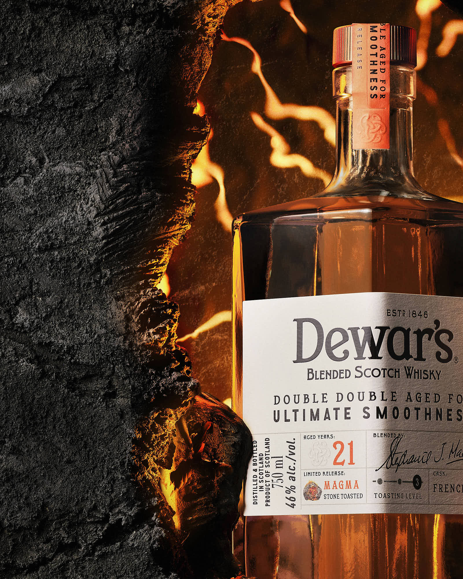 Close-up of a whiskey bottle against a dark background, highlighting its label and amber liquid.