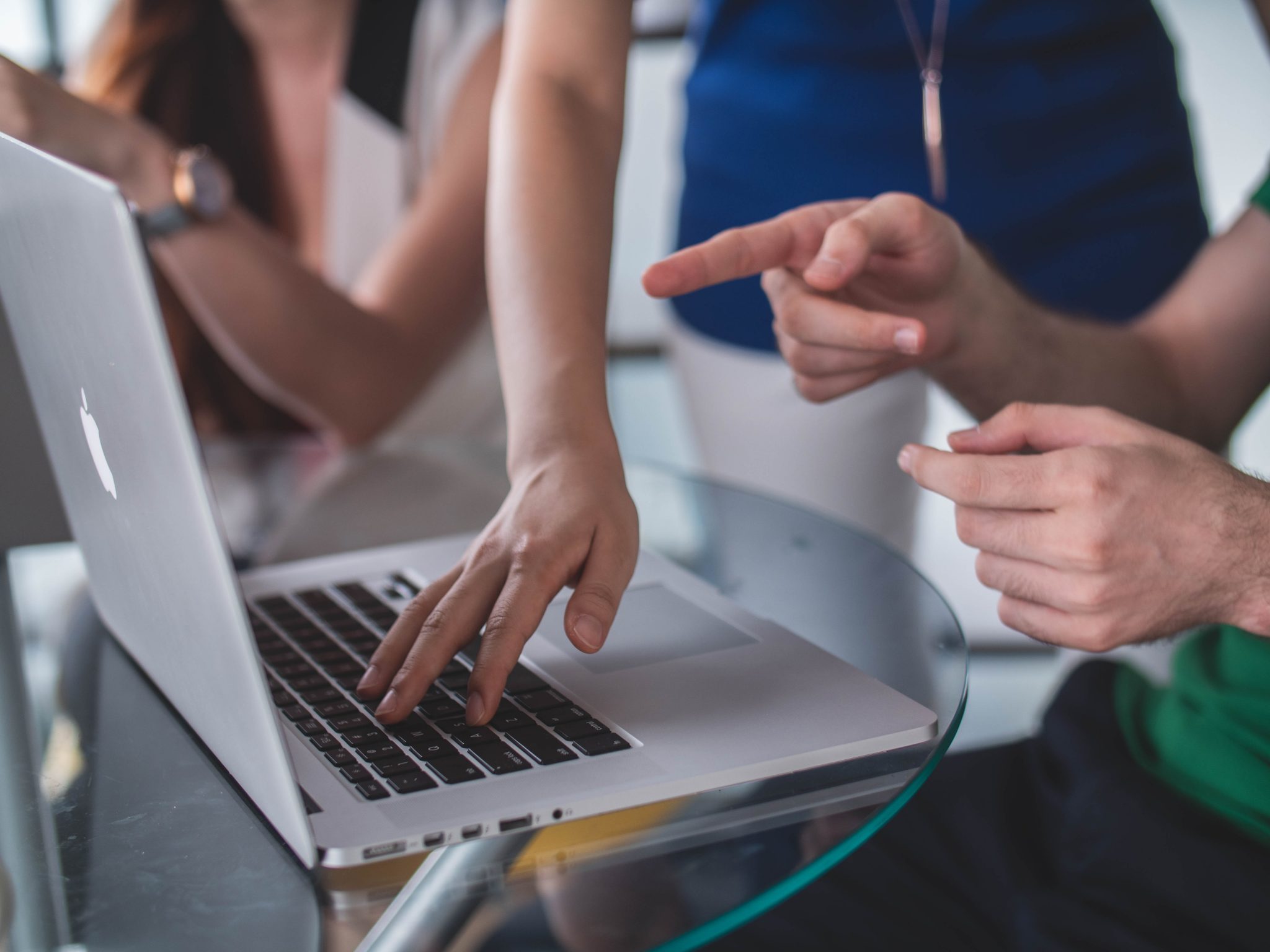 people around laptop | 10 questions to ask before choosing a website developer