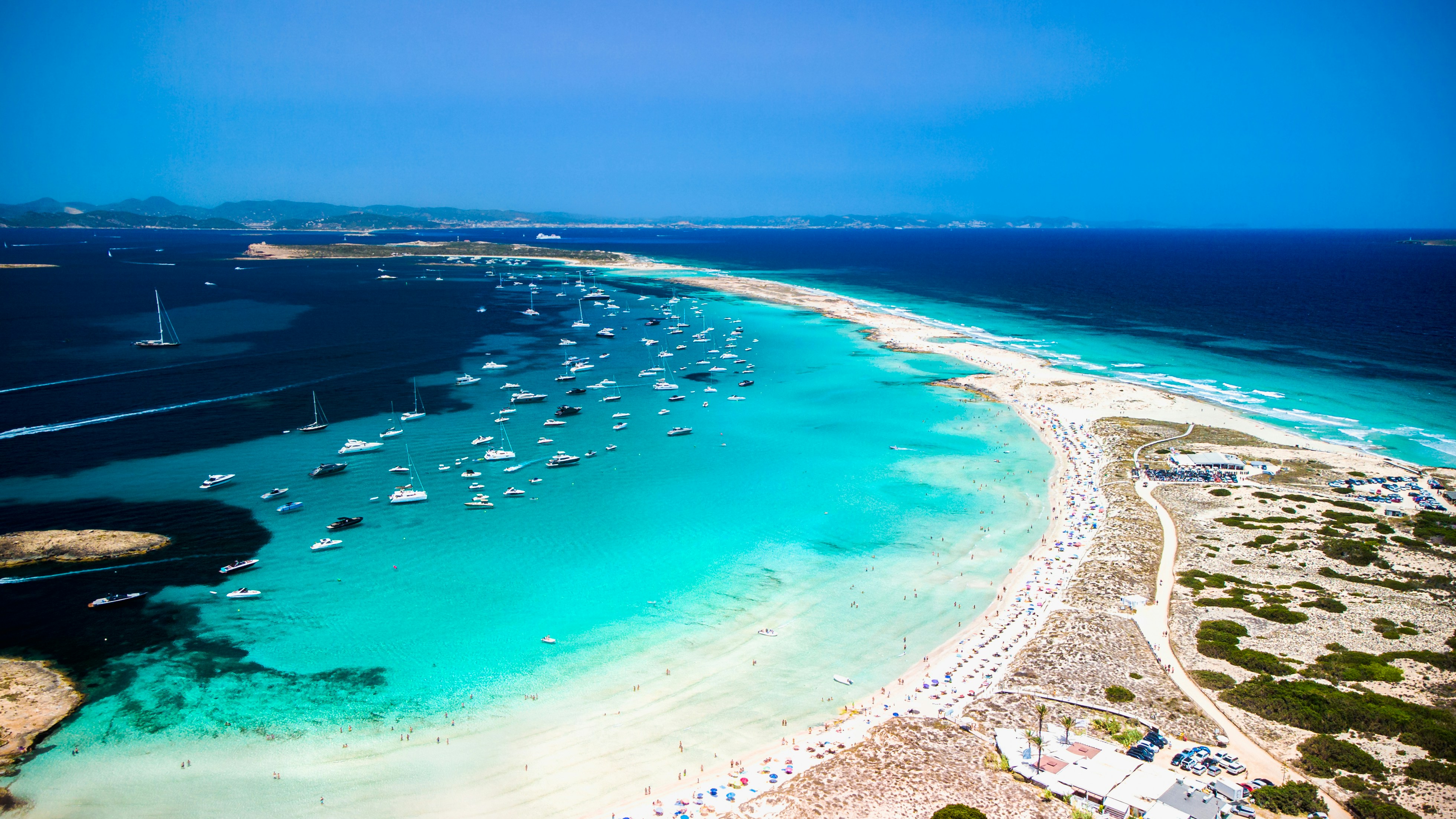 a beach with boats and water