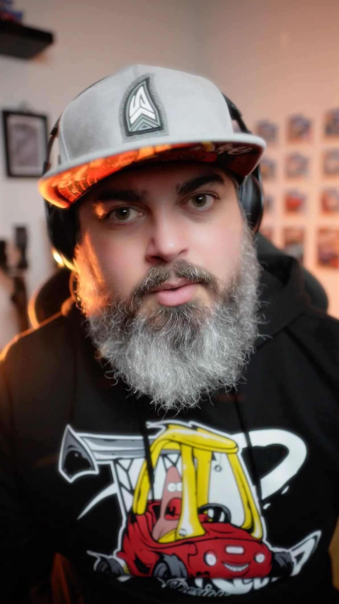 Portrait of Kris Brescia, senior graphic designer at Slow Knife Design, wearing branded apparel in a creative studio environment.