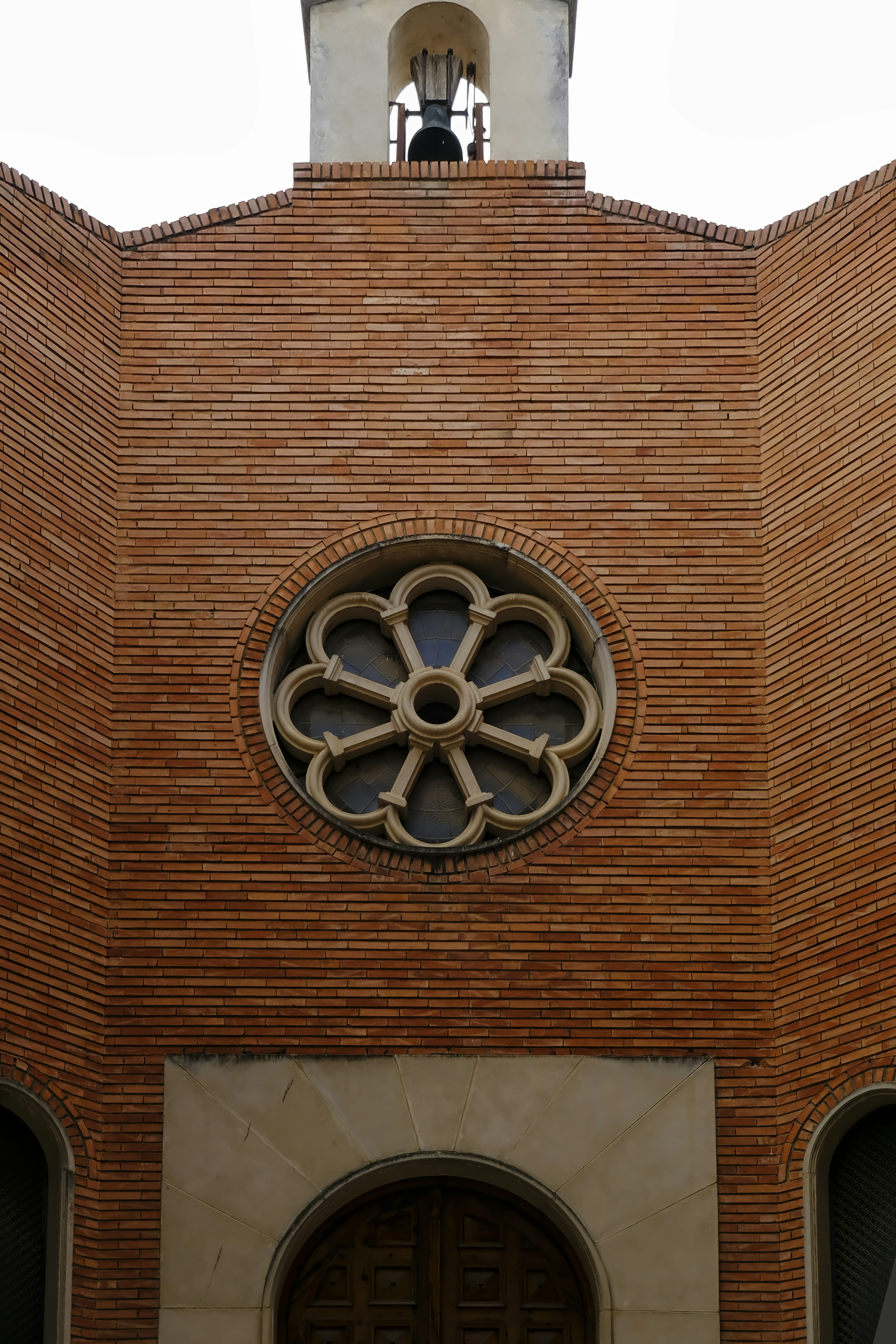brown brick wall with black and silver round wall clock