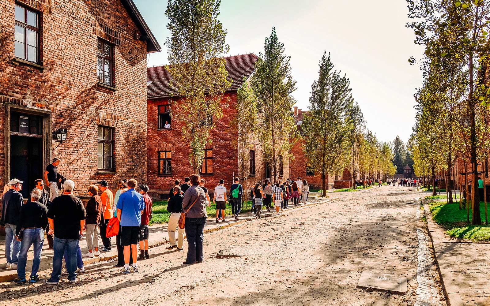 Besökare som går genom Auschwitz-Birkenau-lägret, en del av en guidad tur i Polen.