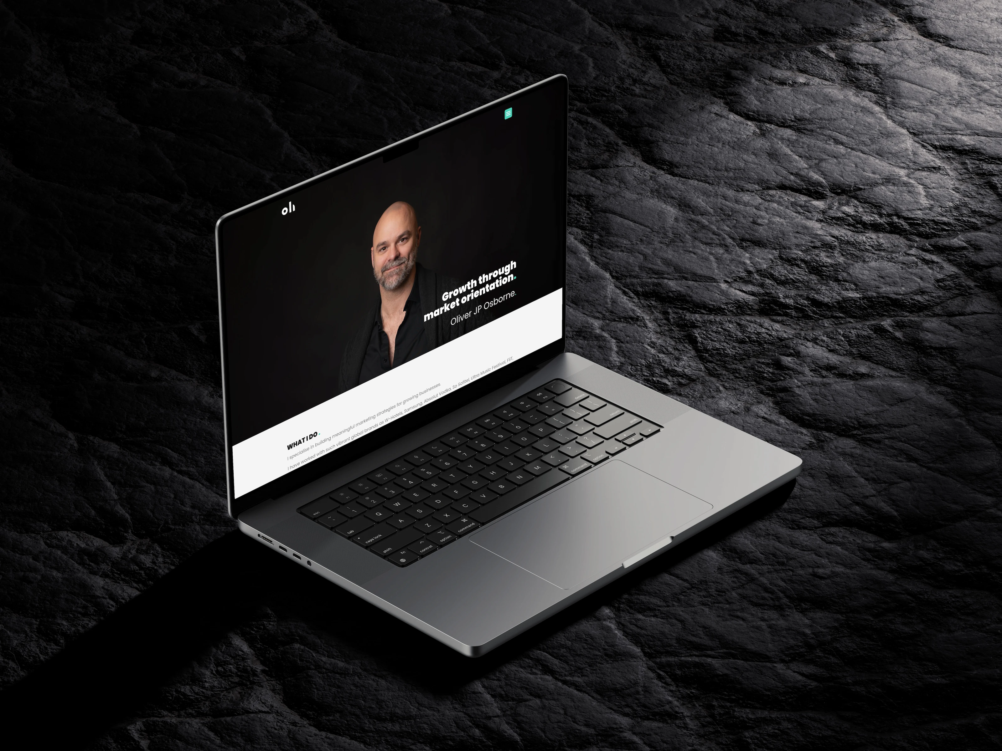 Personal website for marketer Oliver JP Osborne on a laptop: portrait hero with the headline “Growth through market orientation,” on dark stone.