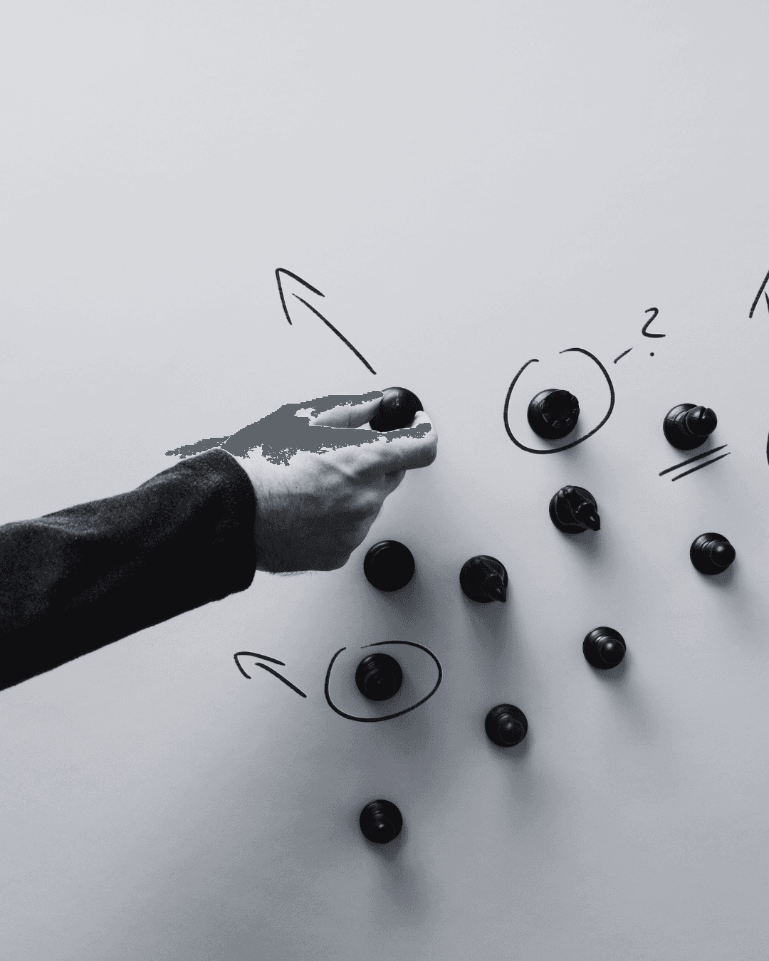 Person in dark clothing standing in moody, atmospheric lighting