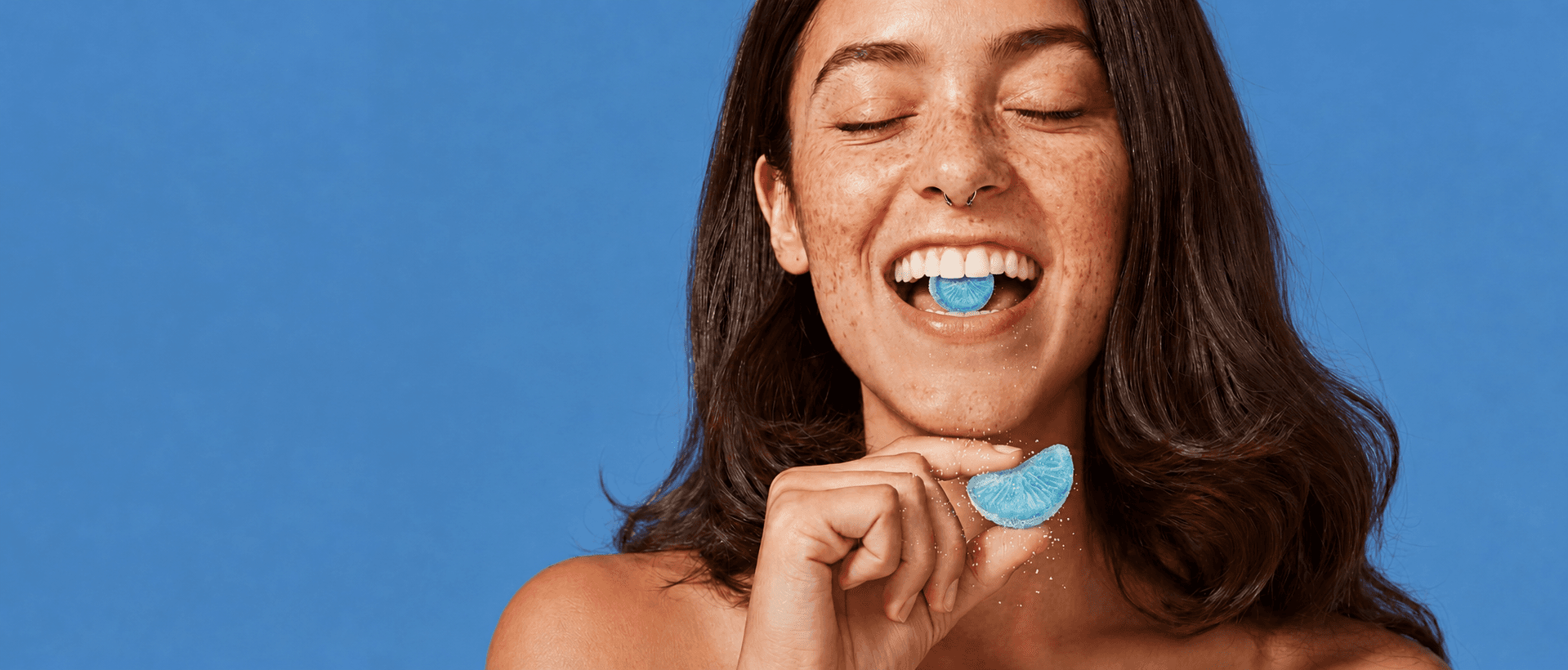 Woman holding a supplement gummy