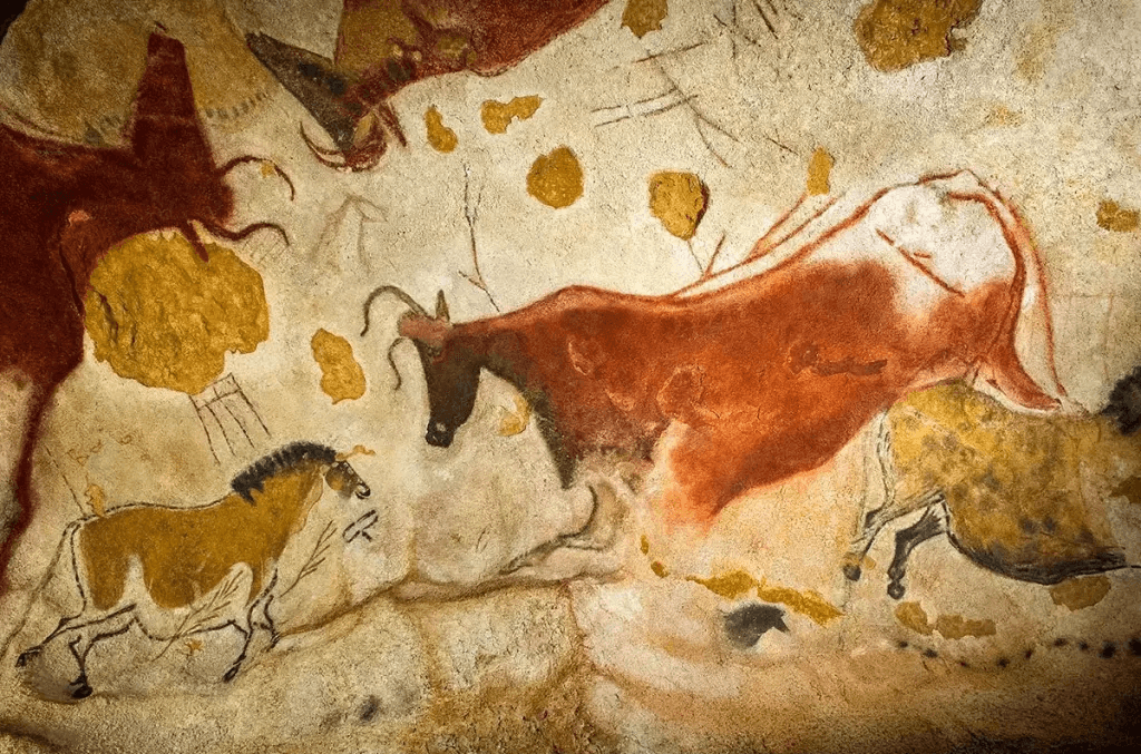 Lascaux II cave painting replica showing aurochs and horses in ochre and red pigment.