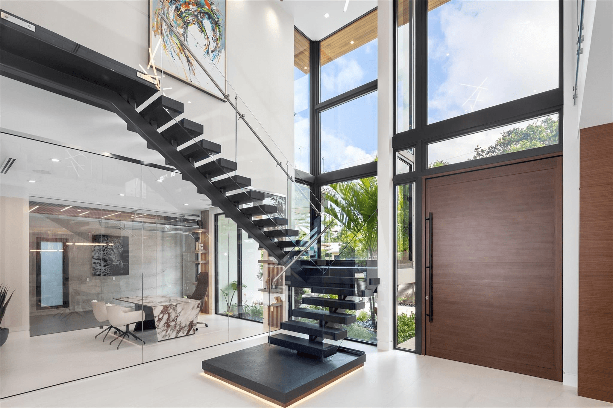 Luxury residential entrance with floating staircase
