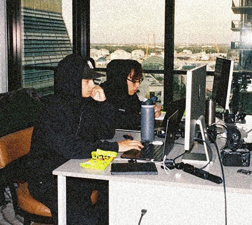 man sitting while having coffee and using laptop