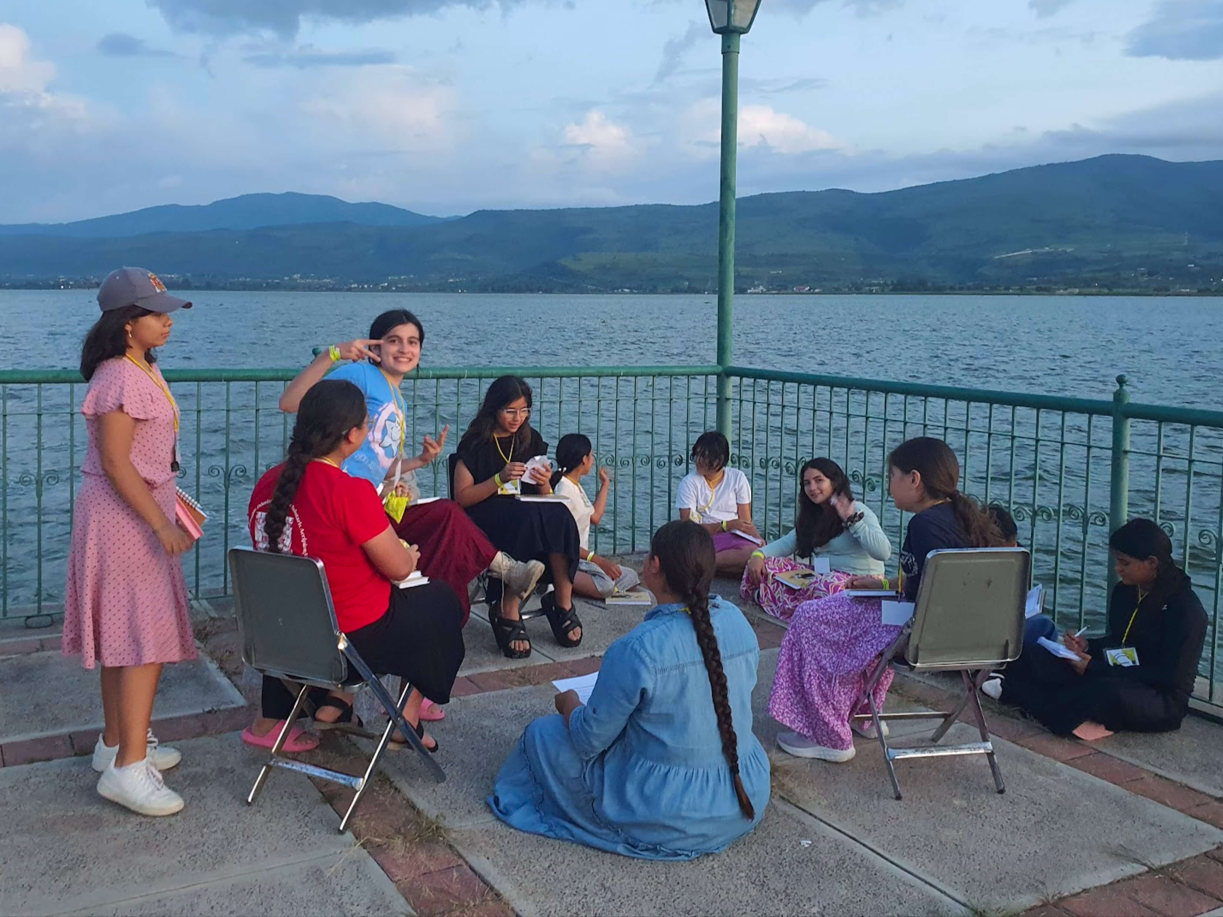 a group of children sitting on steps in front of a building