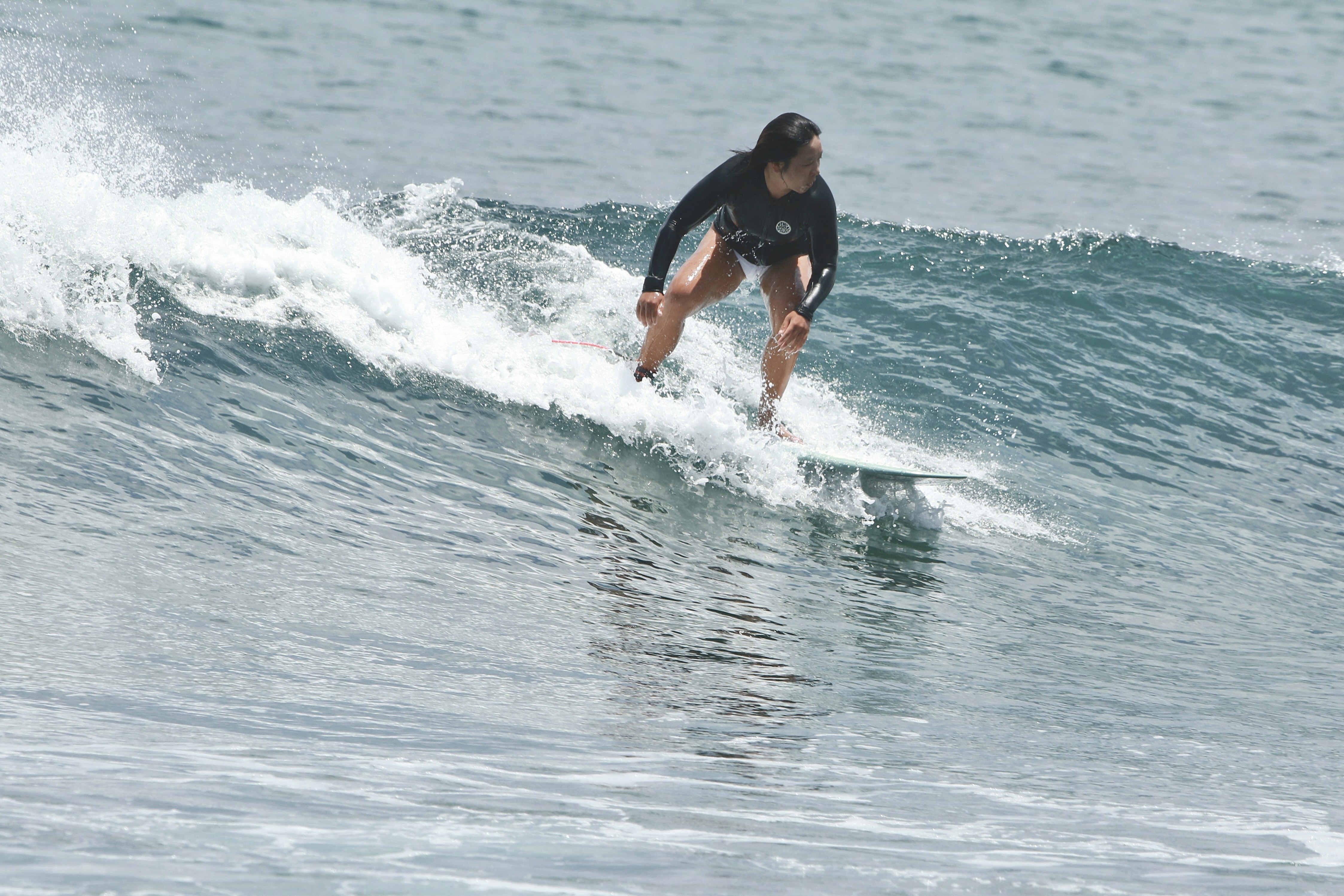 A man standing with Sufboard