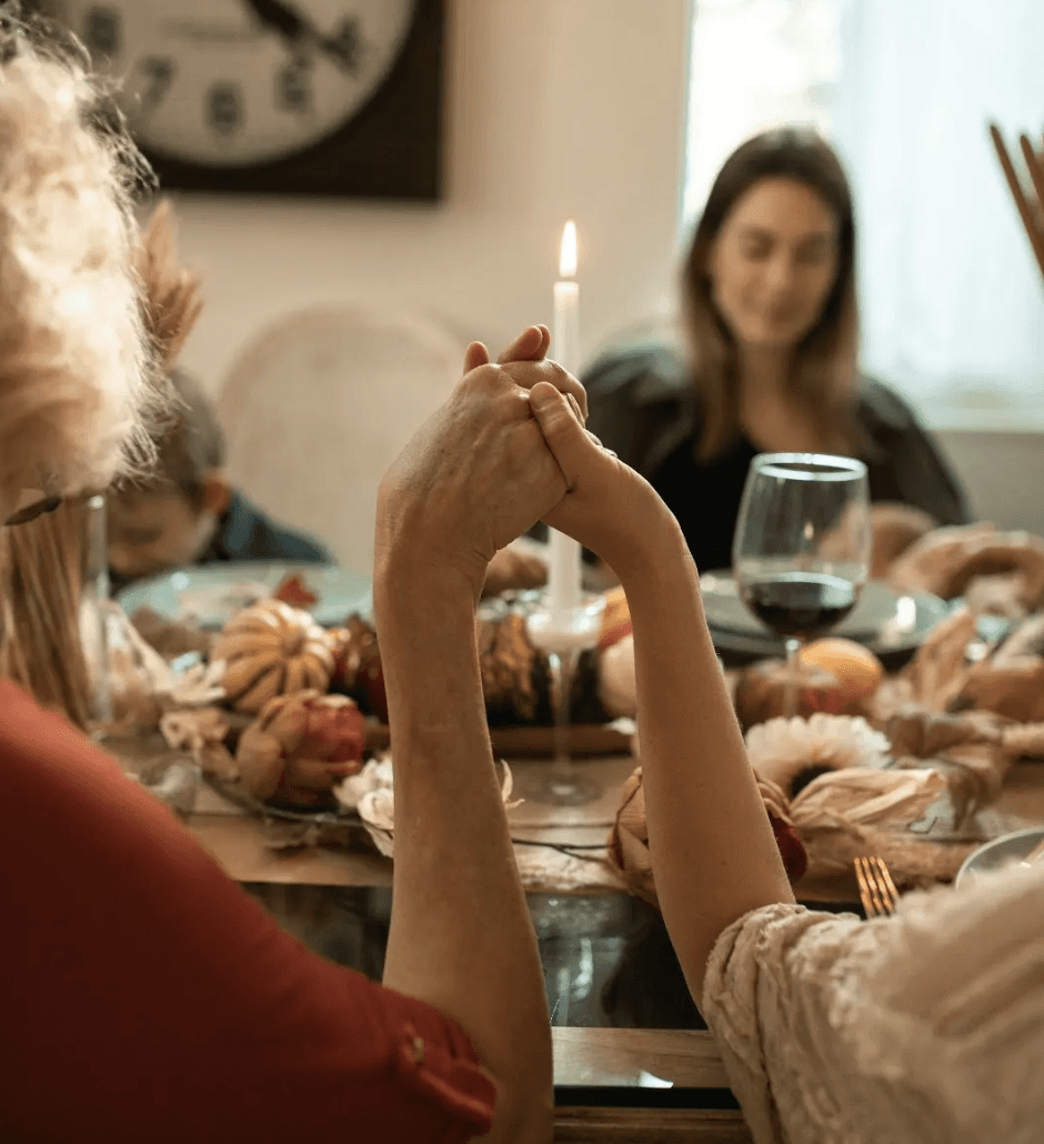 Conversion Truth for Families - 4 young women placing their hands on the back of a woman in a green top.