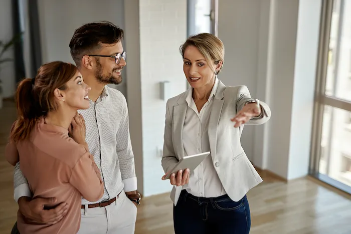 Two designers collaborating in front of computer screens in a creative studio.