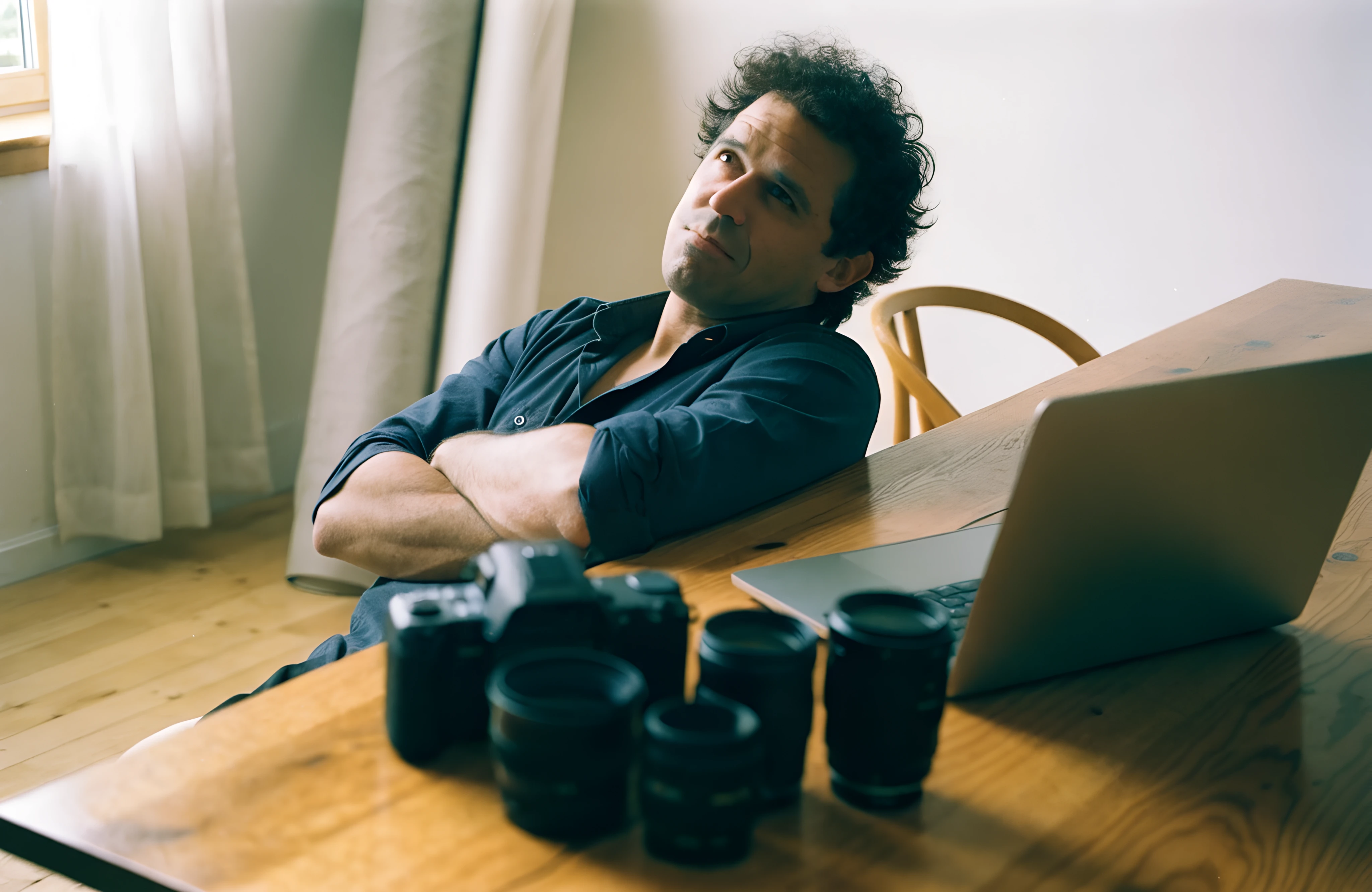 Photographer leaning back from his laptop, asking whether Wix is bad for SEO for his DIY website