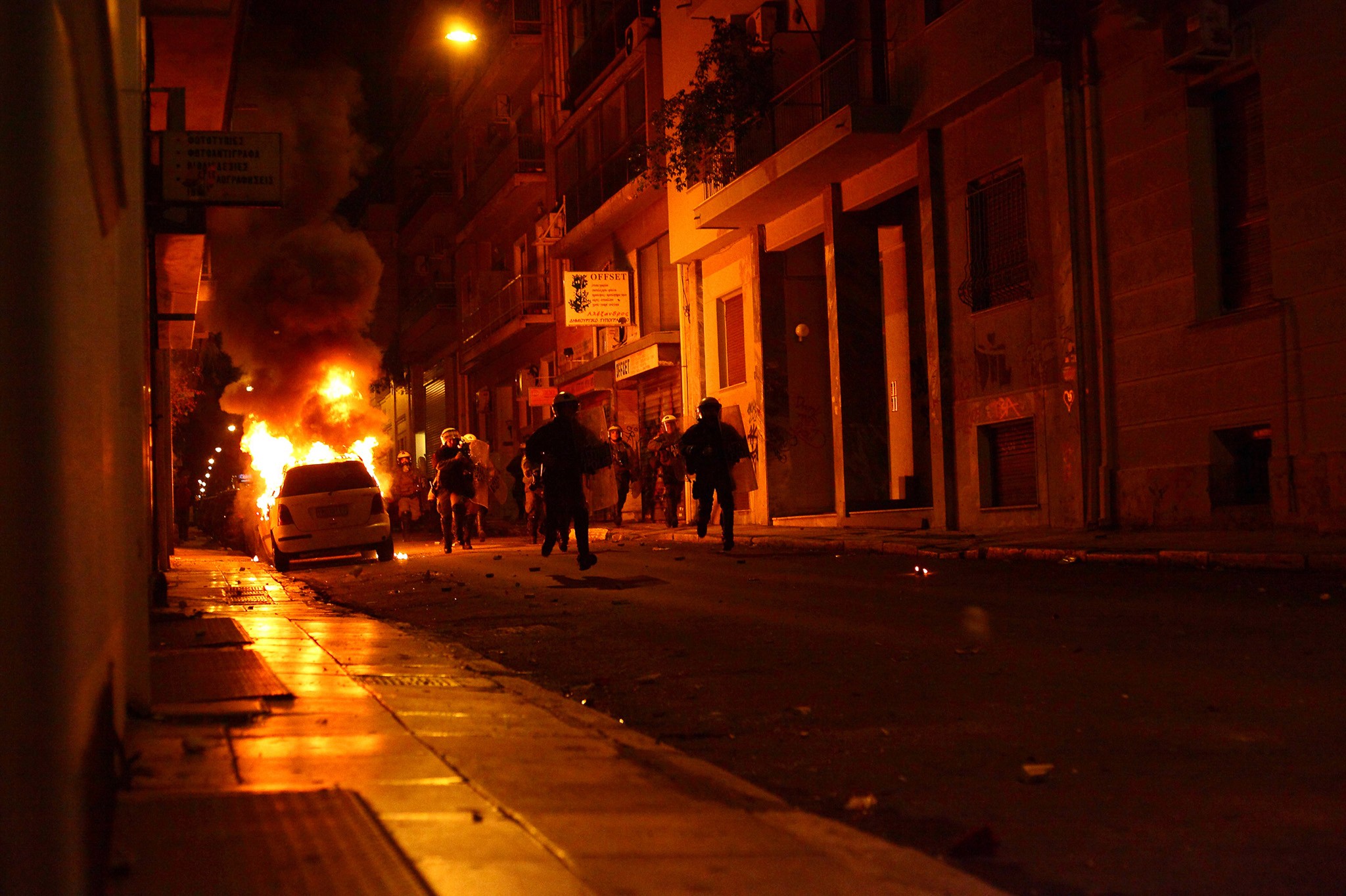 Riots in Athens, a protester is throwing a molotov cocktail. Action Photography, BBC Published