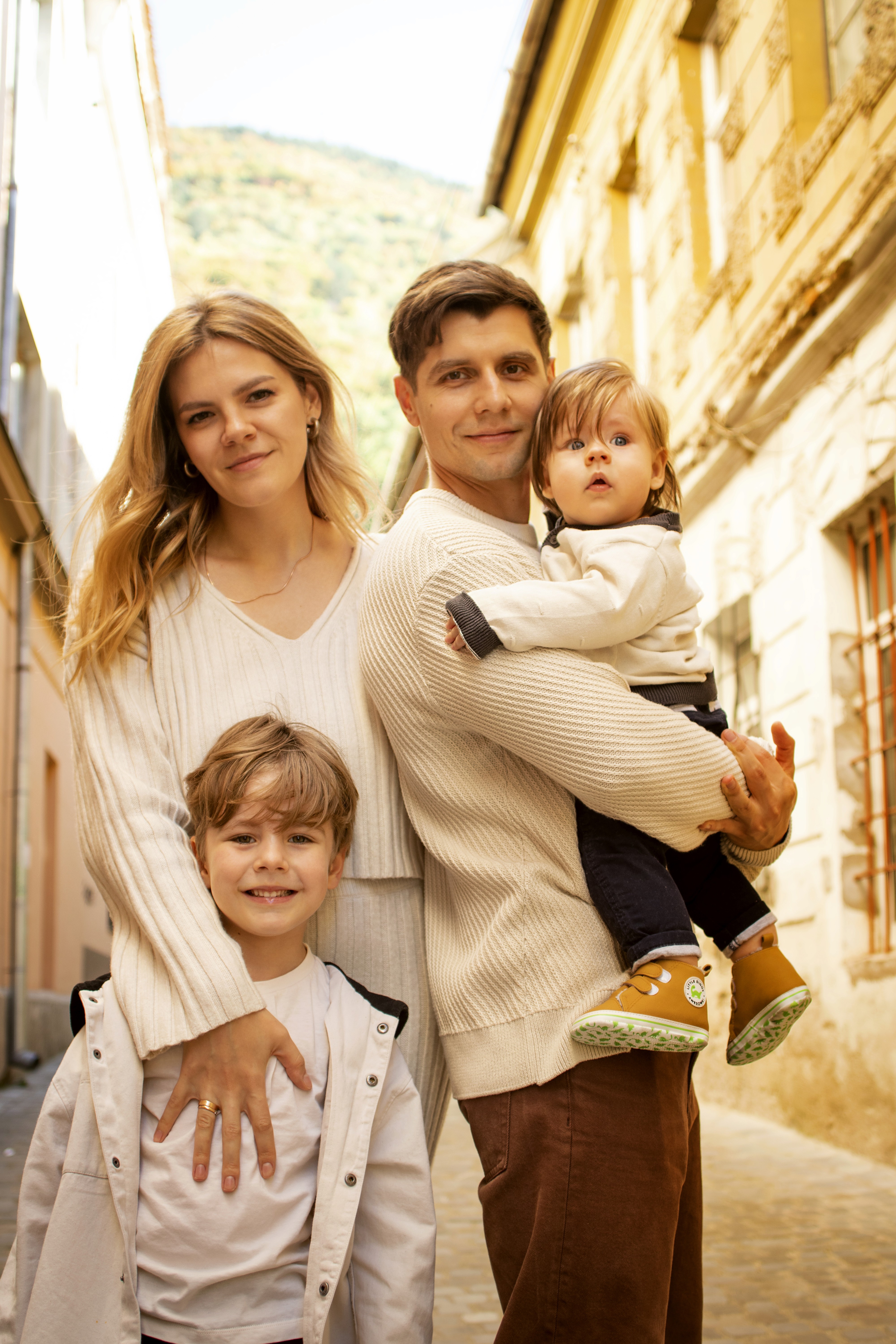 man in white shirt carrying girl in gray shirt