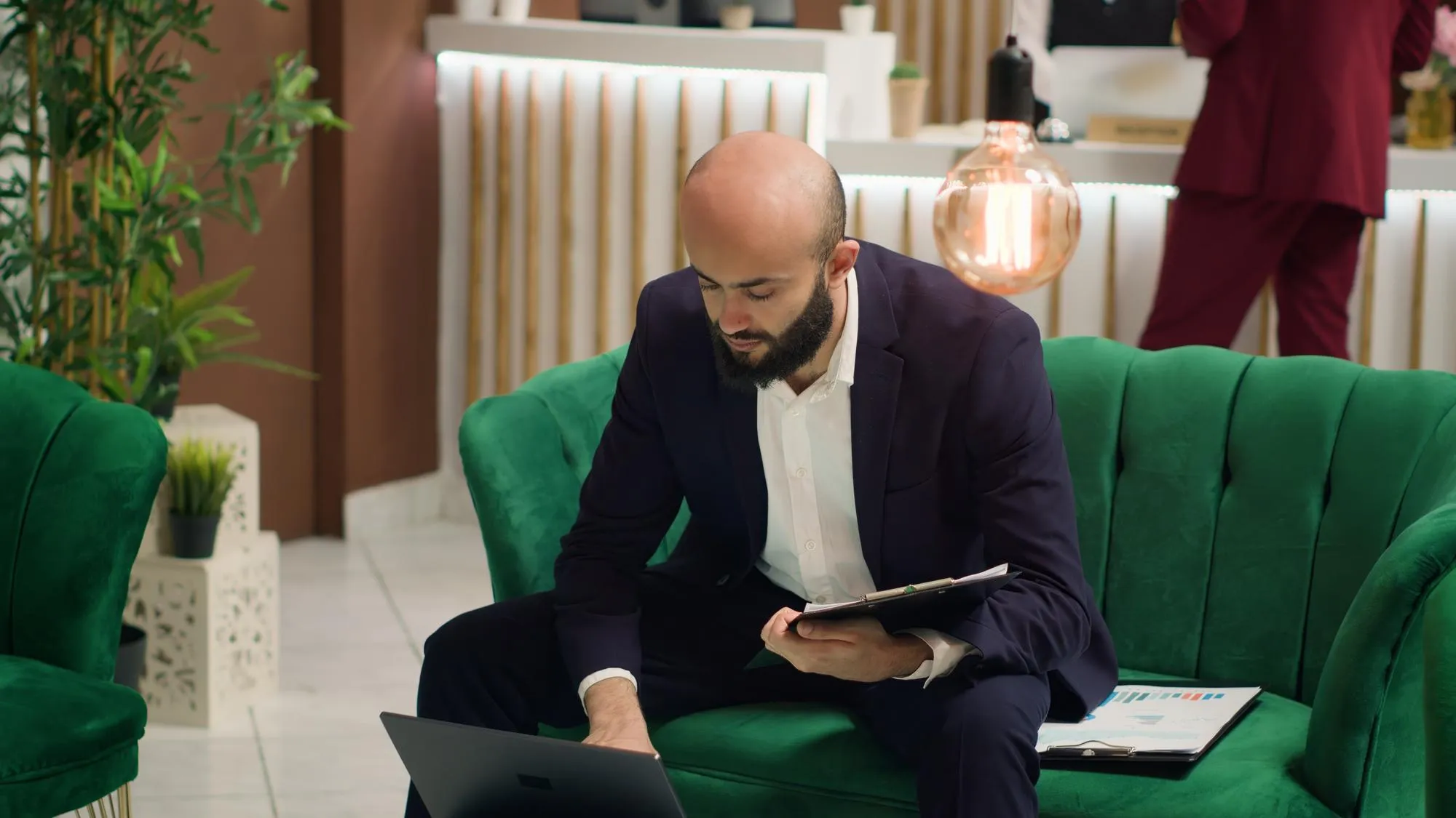 Businessman working on a laptop in a modern lounge