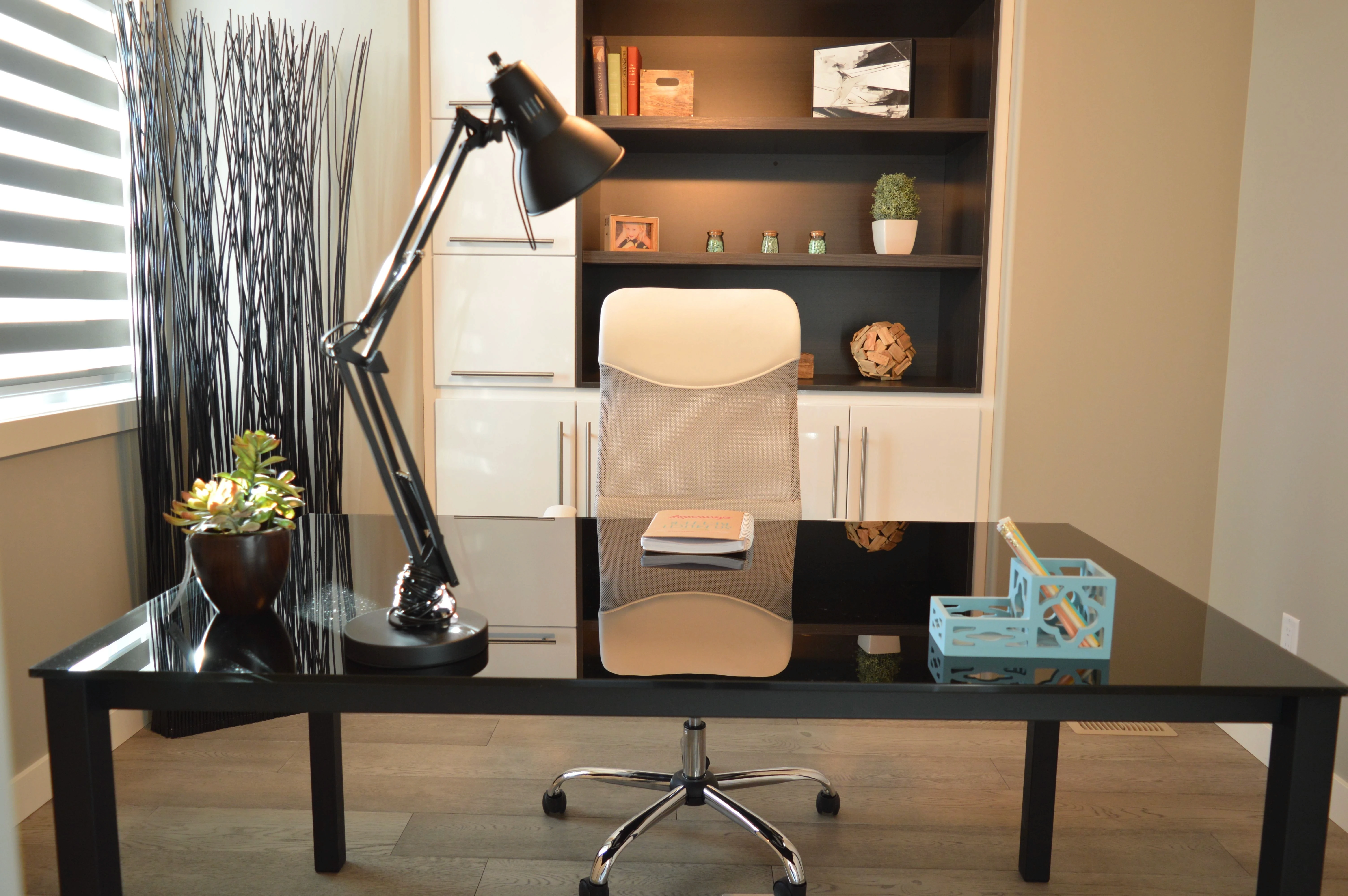 Modern gym corner with fitness equipment, surfboard decor, and wooden wall storage.