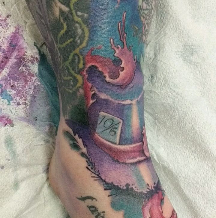 Colour watercolour candle and floral sleeve tattoo on an arm