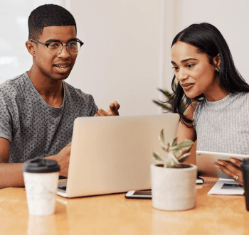 Image of two people staring at computer
