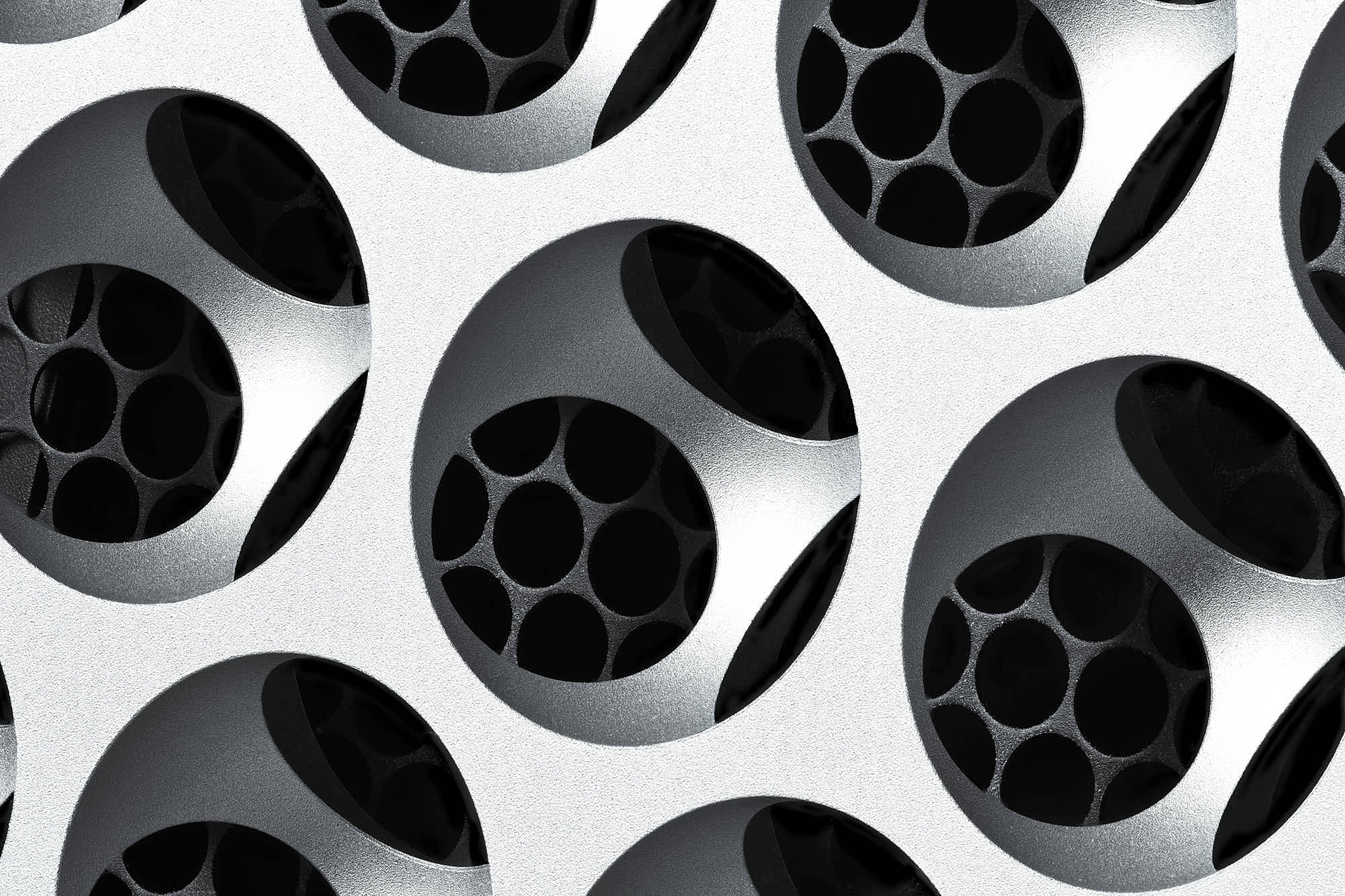 A close-up of circular black and white designs resembling camera lenses or rounded apertures arranged in a pattern.