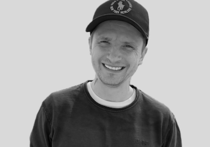 Profile portrait of a man in a grey shirt