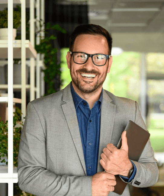 A man holding office file and smiling